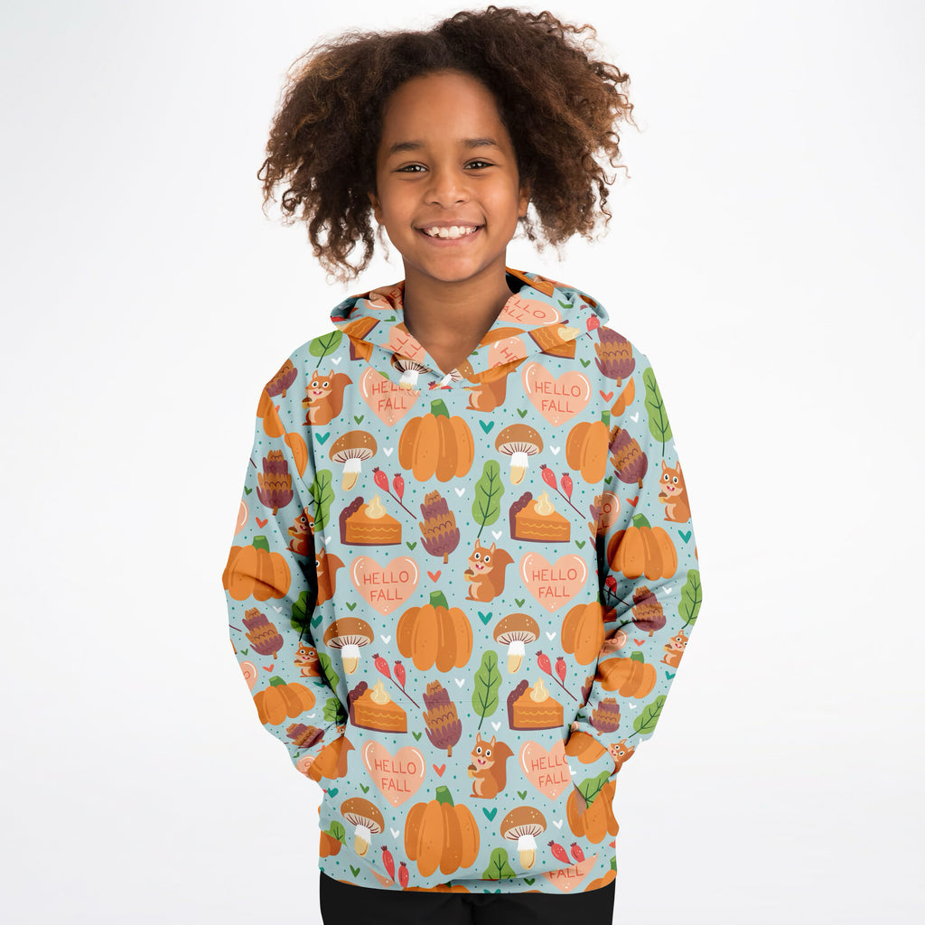 A child wearing a light blue kids hello fall autumn themed hoodie with pumpkins squirrels and cozy cotton fleece