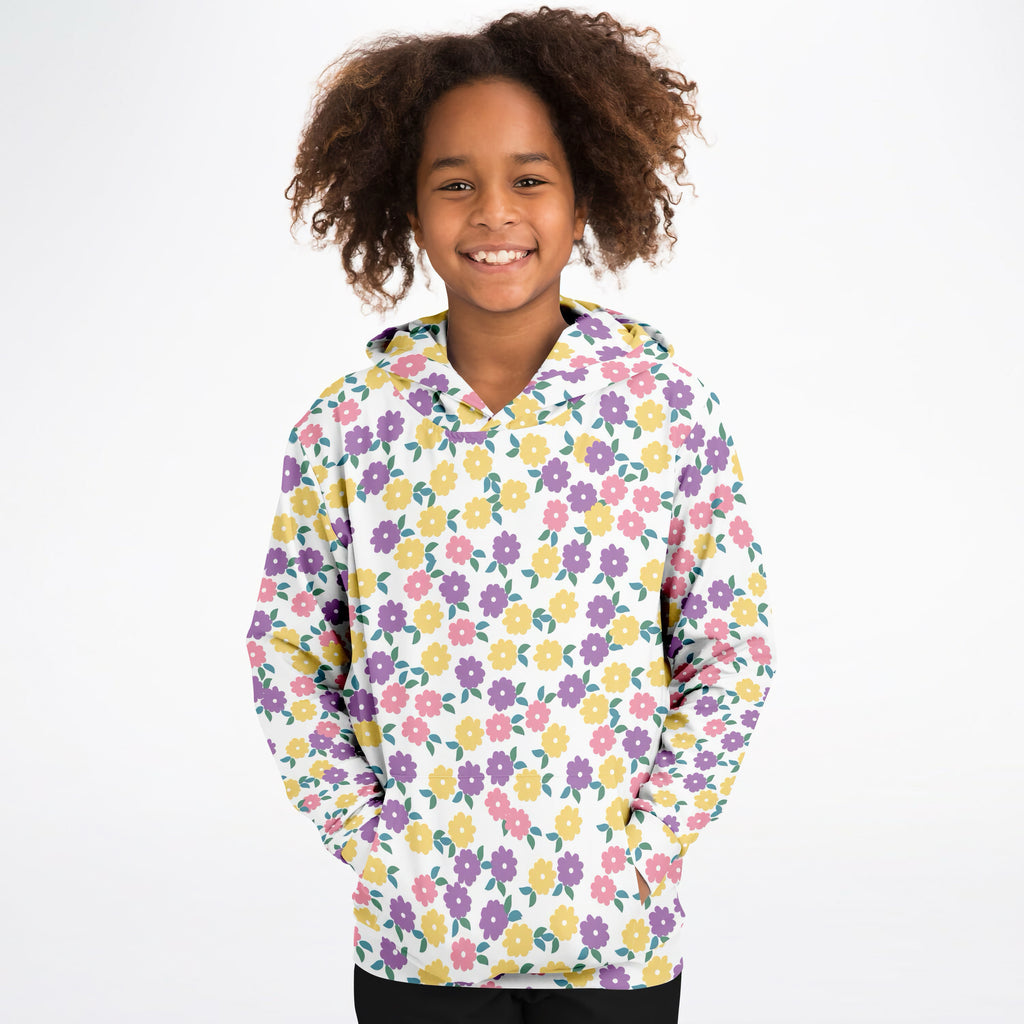 A child wearing a girls colorful floral hoodie in white cotton fleece with purple pink and yellow flowers visible from the front