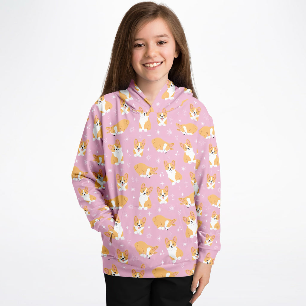 Girls pink corgi dog hoodie with playful all-over tan and white cartoon corgis in cozy cotton fleece fabric