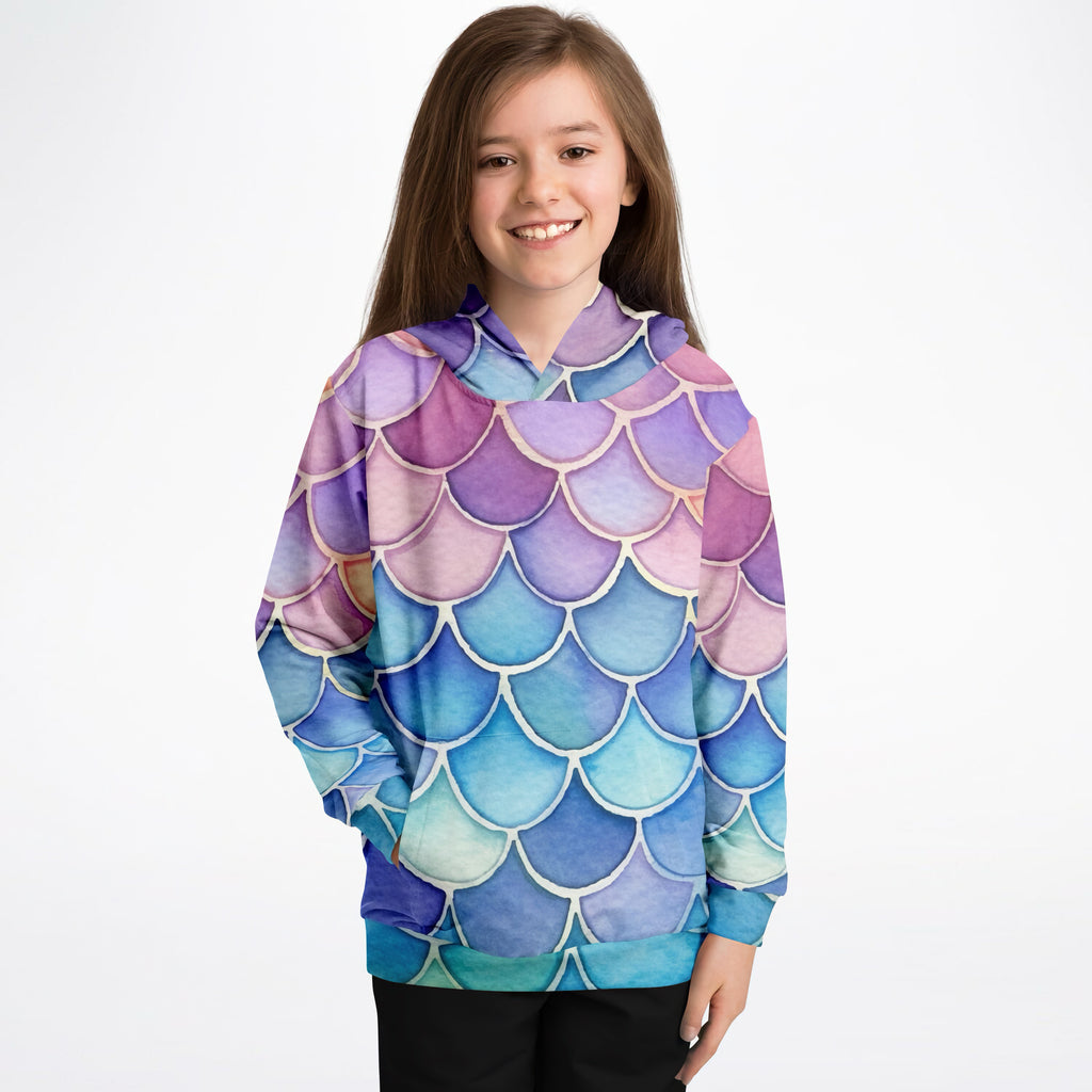 A child wearing a girls watercolor mermaid hoodie with vibrant purple pink blue teal mermaid scales in cozy cotton fleece
