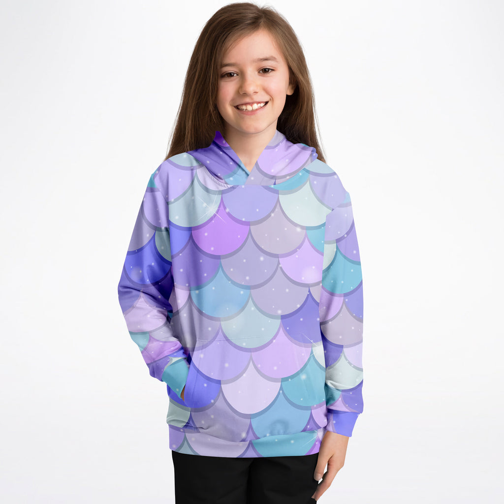 A child wearing a girls purple mermaid hoodie with cozy cotton fleece featuring blue mermaid-scale patterns and subtle white sparkles