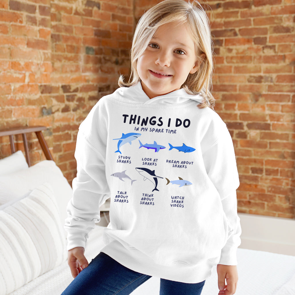 Kids white hoodie with shark graphic and text things i do in my spare time designed for casual wear