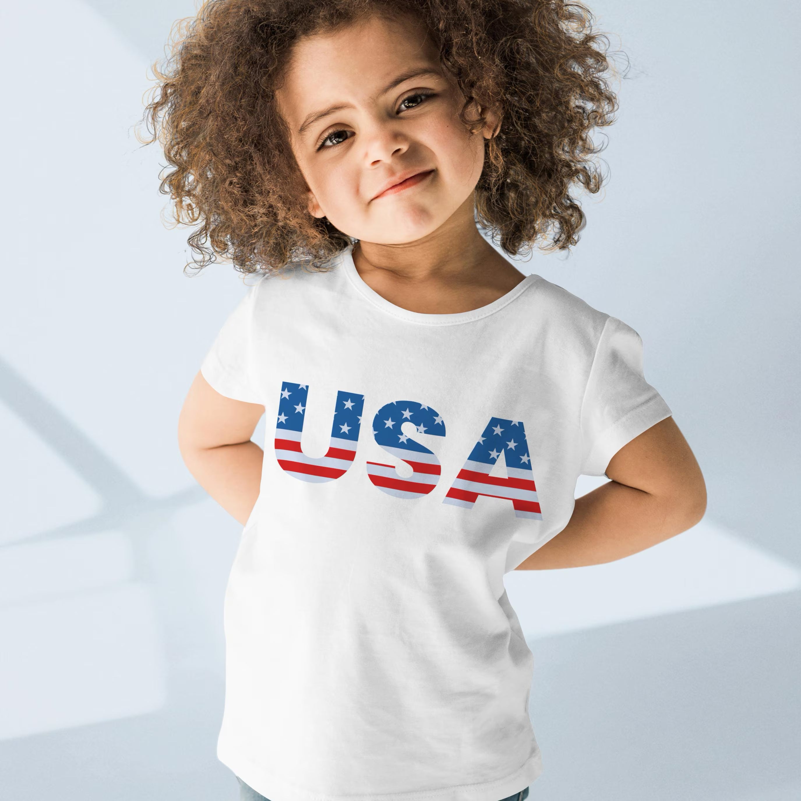 White cotton kids usa t-shirt with bold red white and blue stars and stripes design on the front