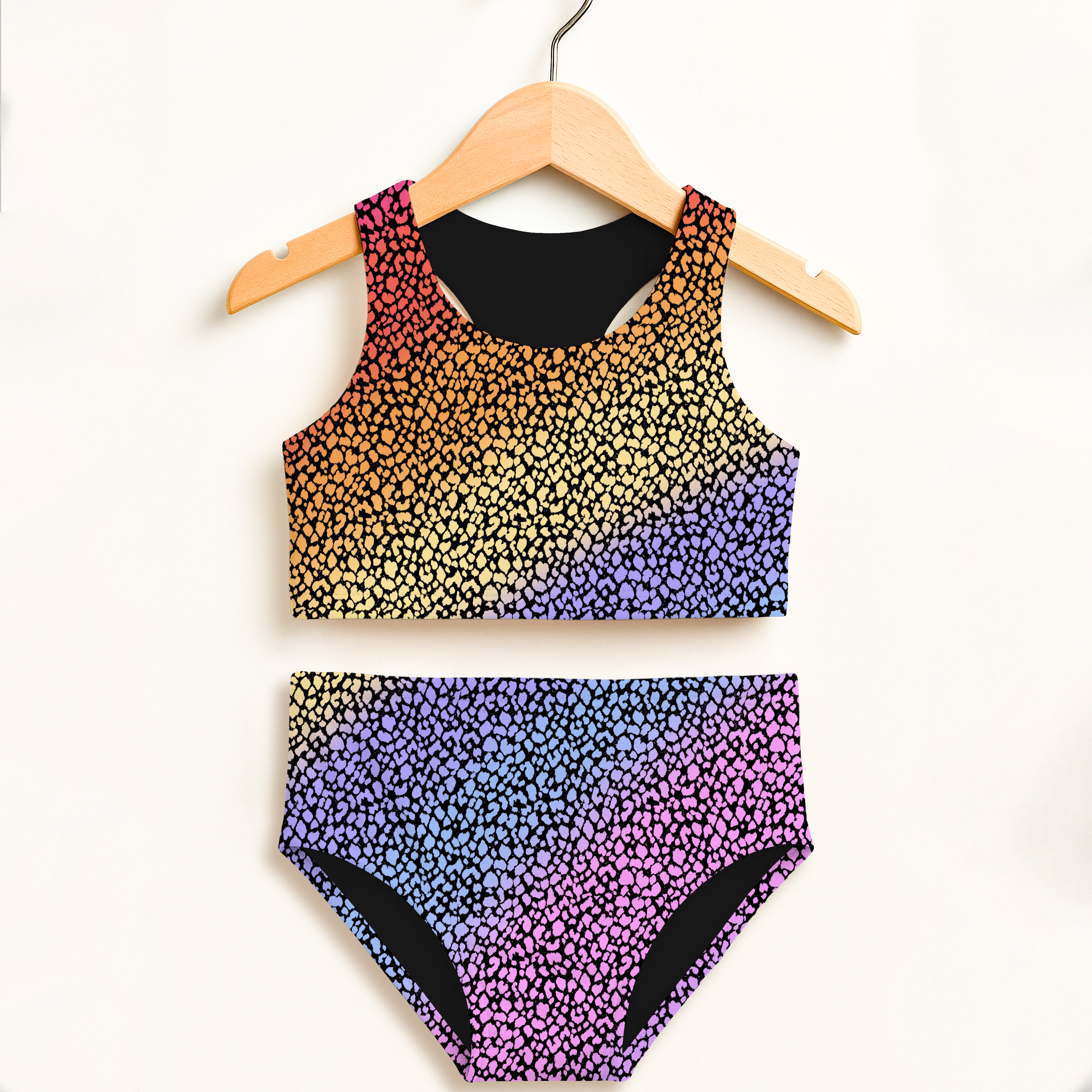 Girls colorful leopard polka dot two piece swimsuit with rainbow gradient and black lining featuring UPF 50+ protection
