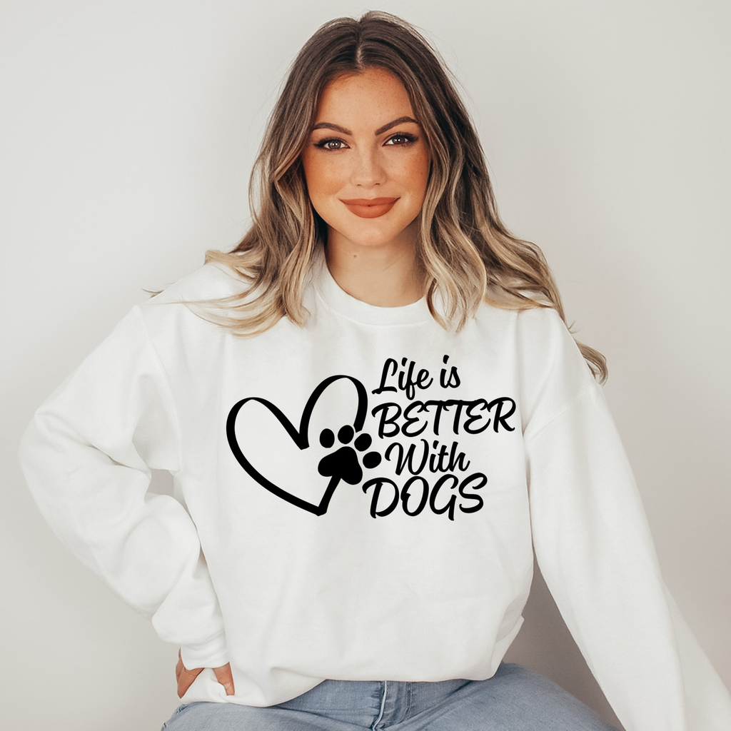Woman wearing a white sweatshirt with 'Life is Better with Dogs' text and paw print design.
