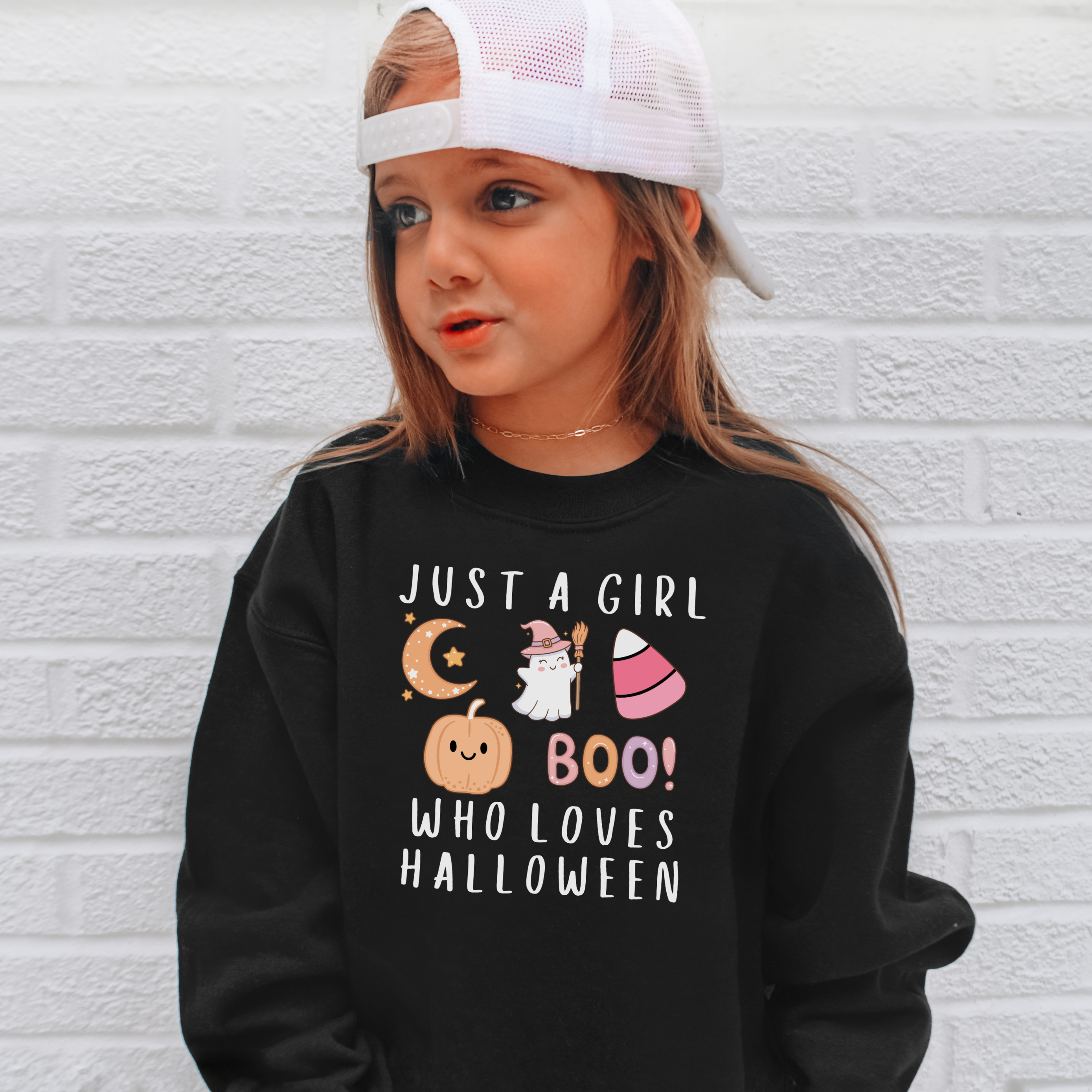 Black long-sleeved halloween sweatshirt for girls with colorful cartoon graphics and white text saying just a girl who loves halloween