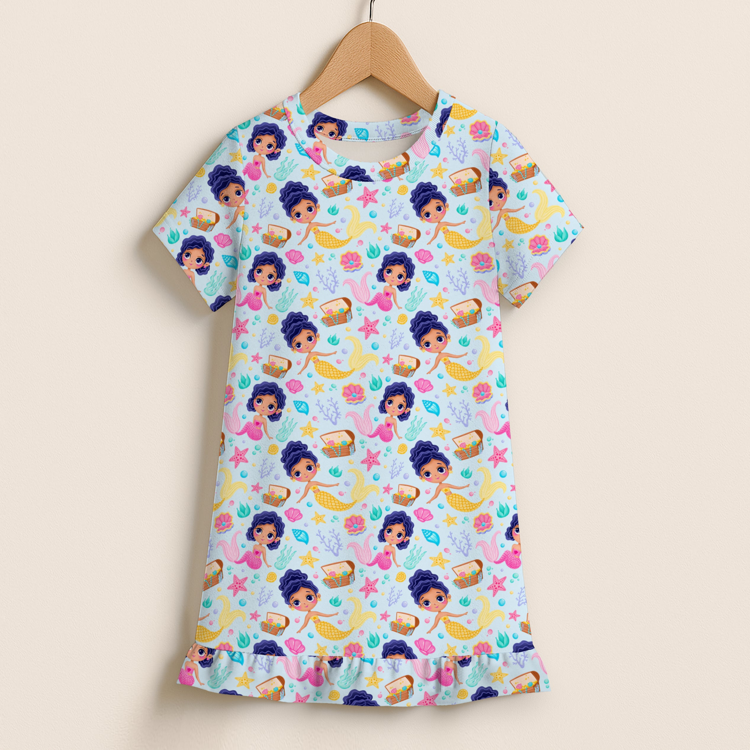 Girls mermaid princess short sleeve ruffle hem dress with playful mermaid pattern in pink blue and yellow on light background