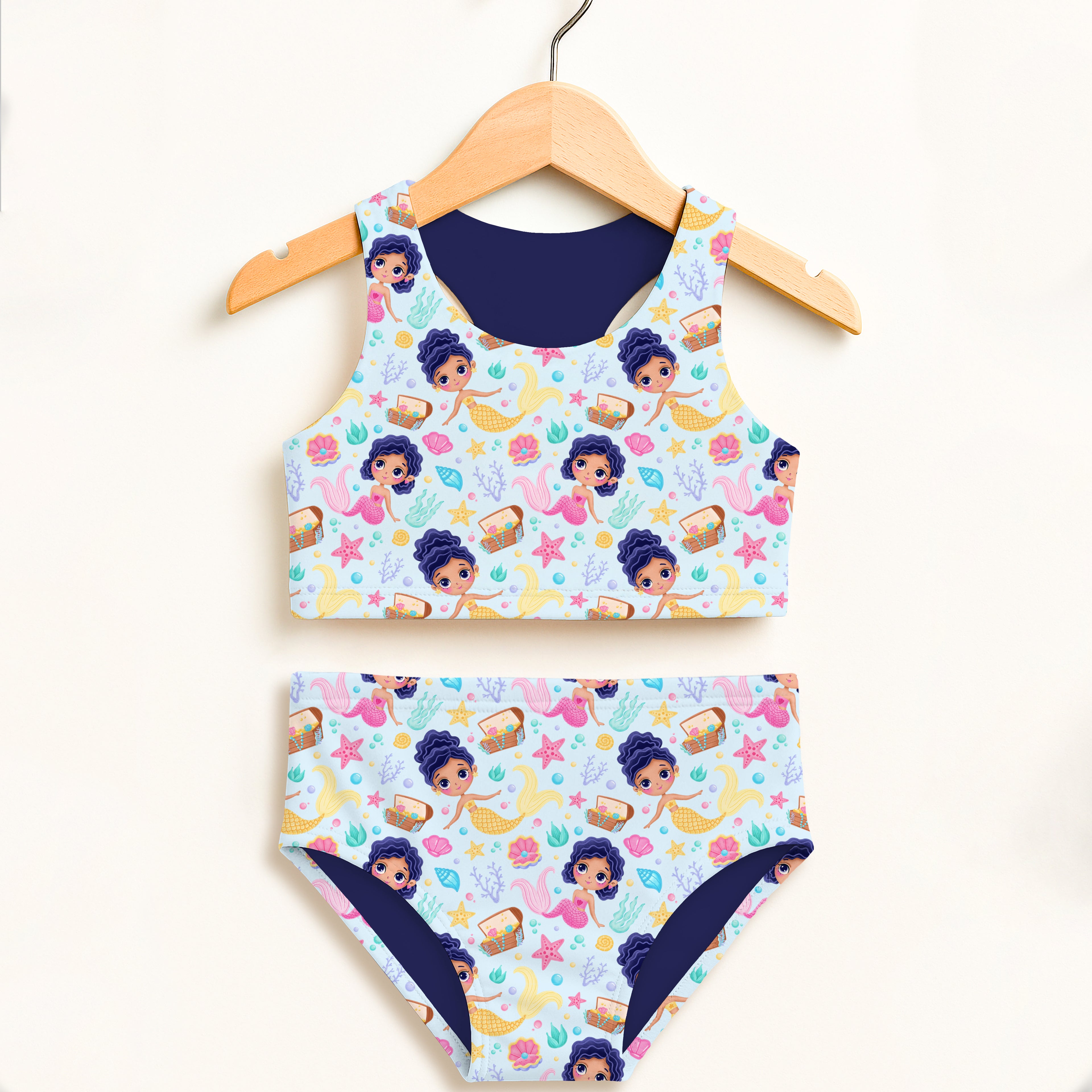 Girls mermaid two piece swimsuit in light blue with cartoon mermaids and sea creatures featuring upf 50+ protection