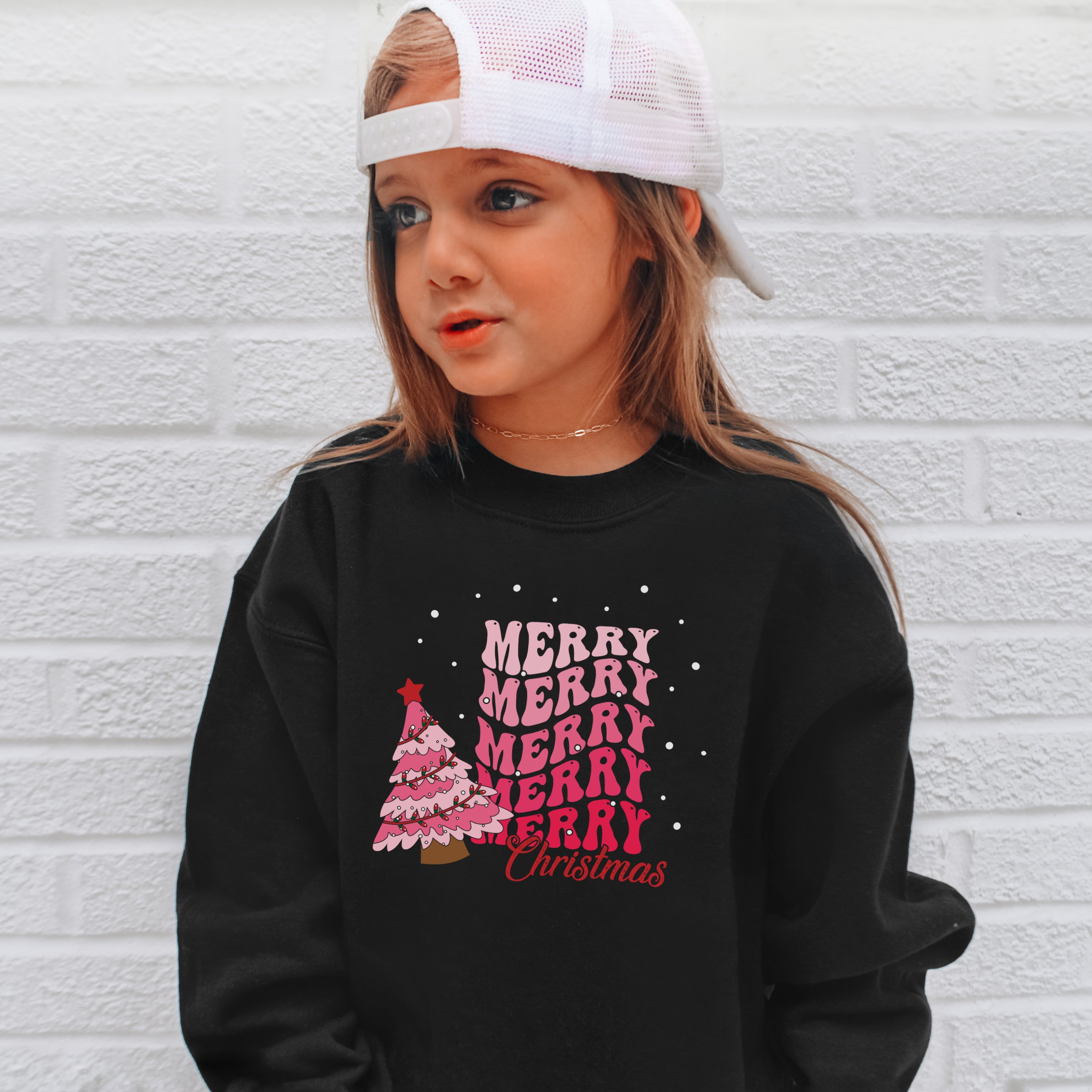 Black long-sleeved kids sweatshirt with pink merry merry merry christmas graphic and festive christmas tree design