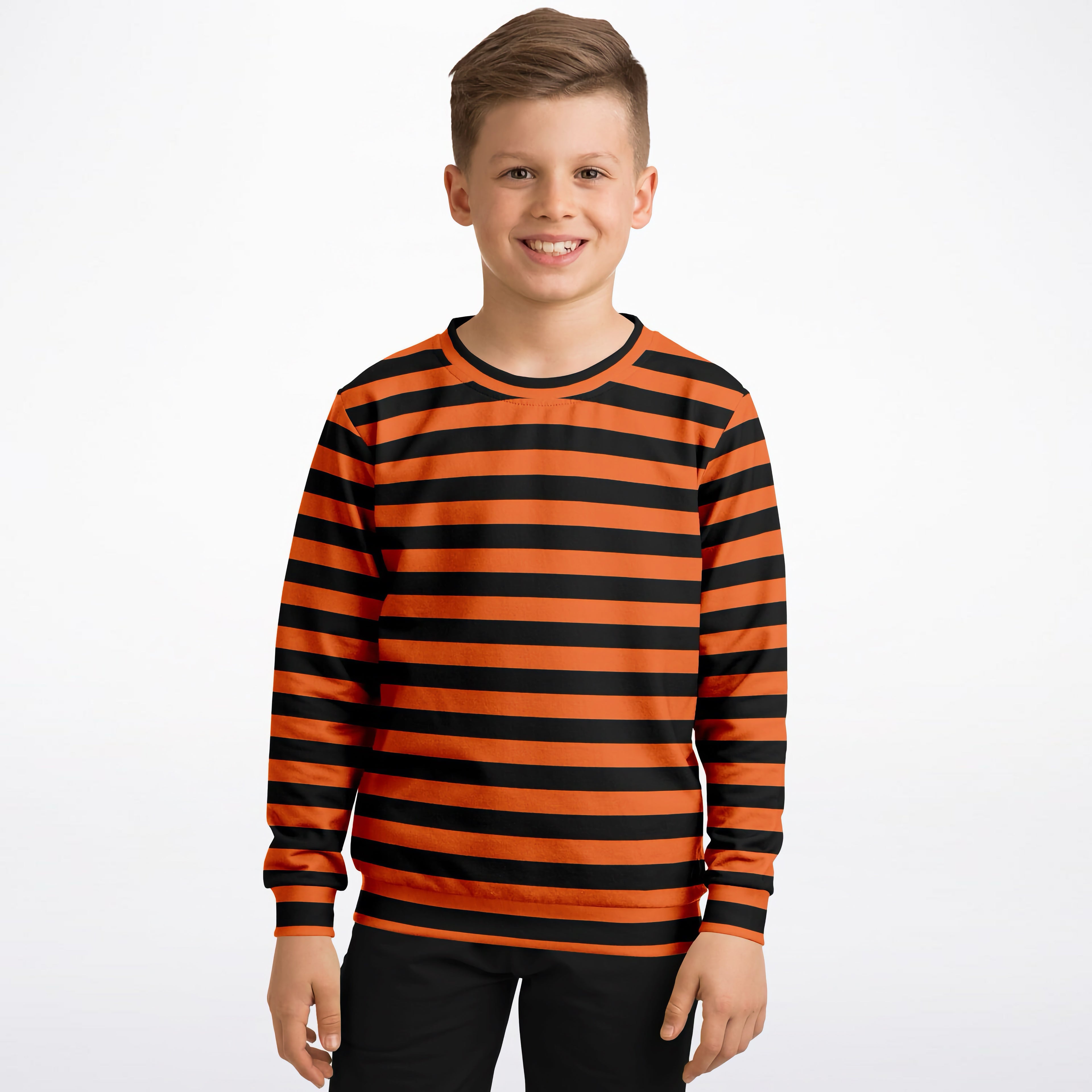 A boy wearing a kids orange and black striped Halloween sweatshirt made of cozy cotton fleece