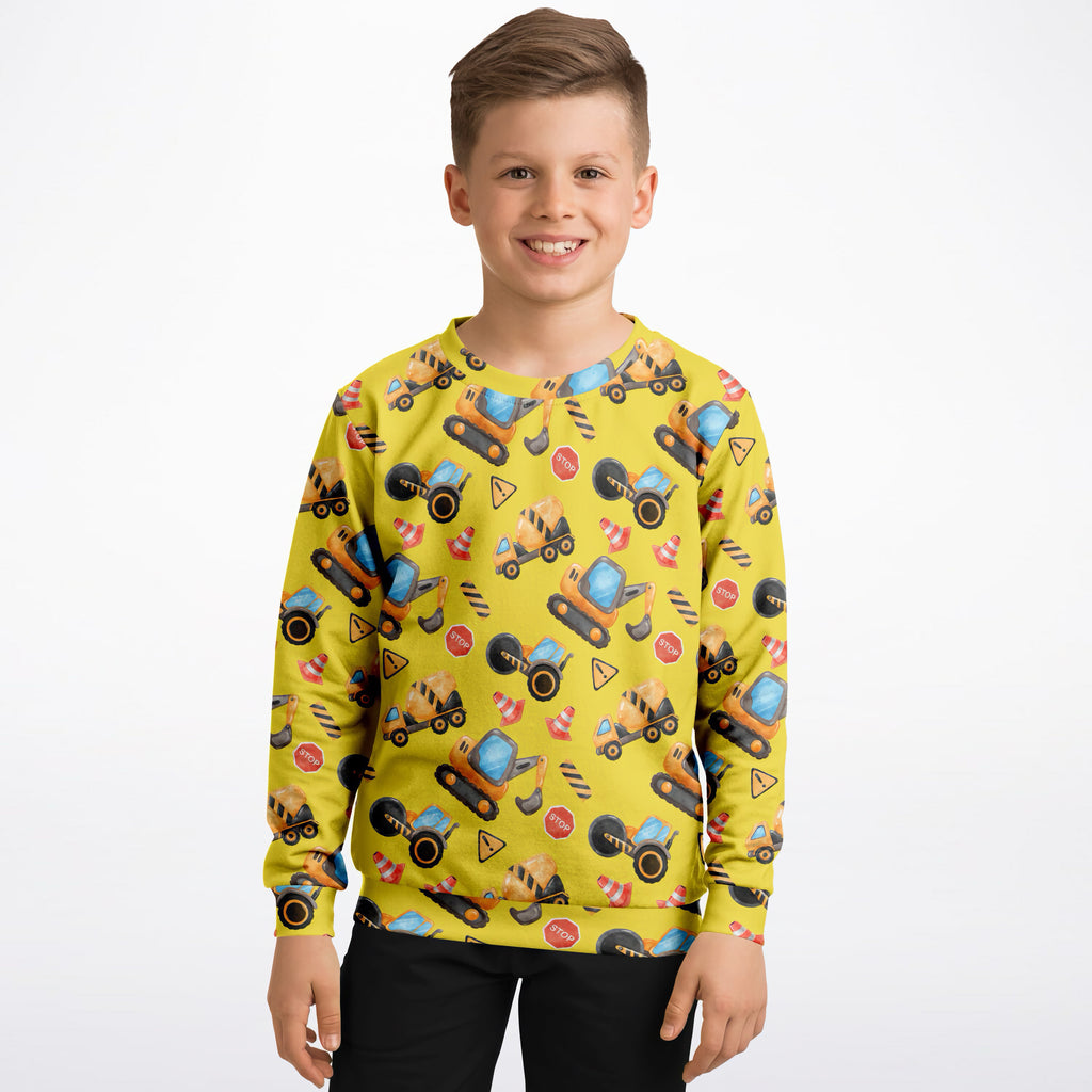 Bright yellow kids construction themed sweatshirt with playful all over print in cozy cotton fleece fabric