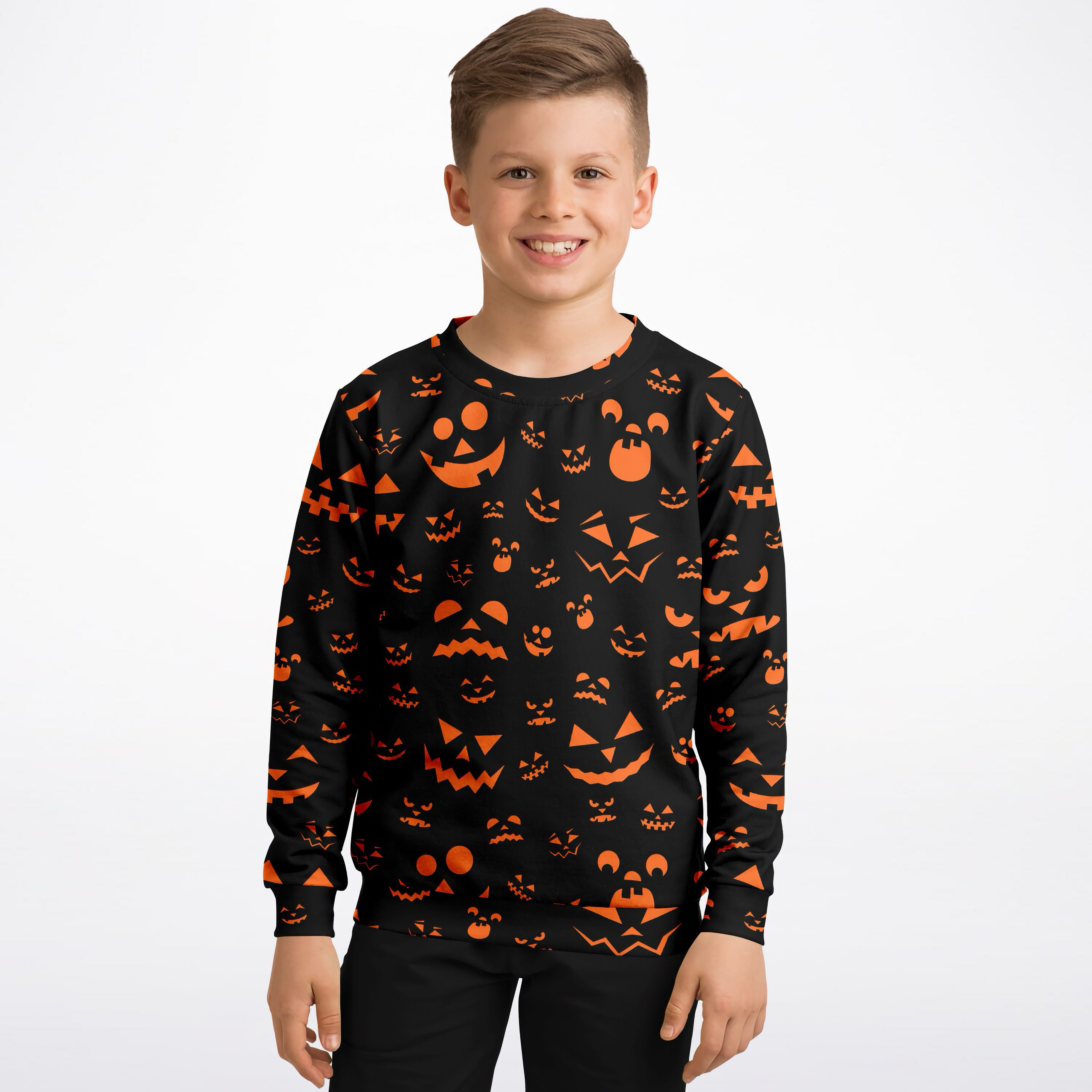 Black long-sleeved kids sweatshirt with vibrant orange halloween jack-o-lantern face made of cozy cotton fleece