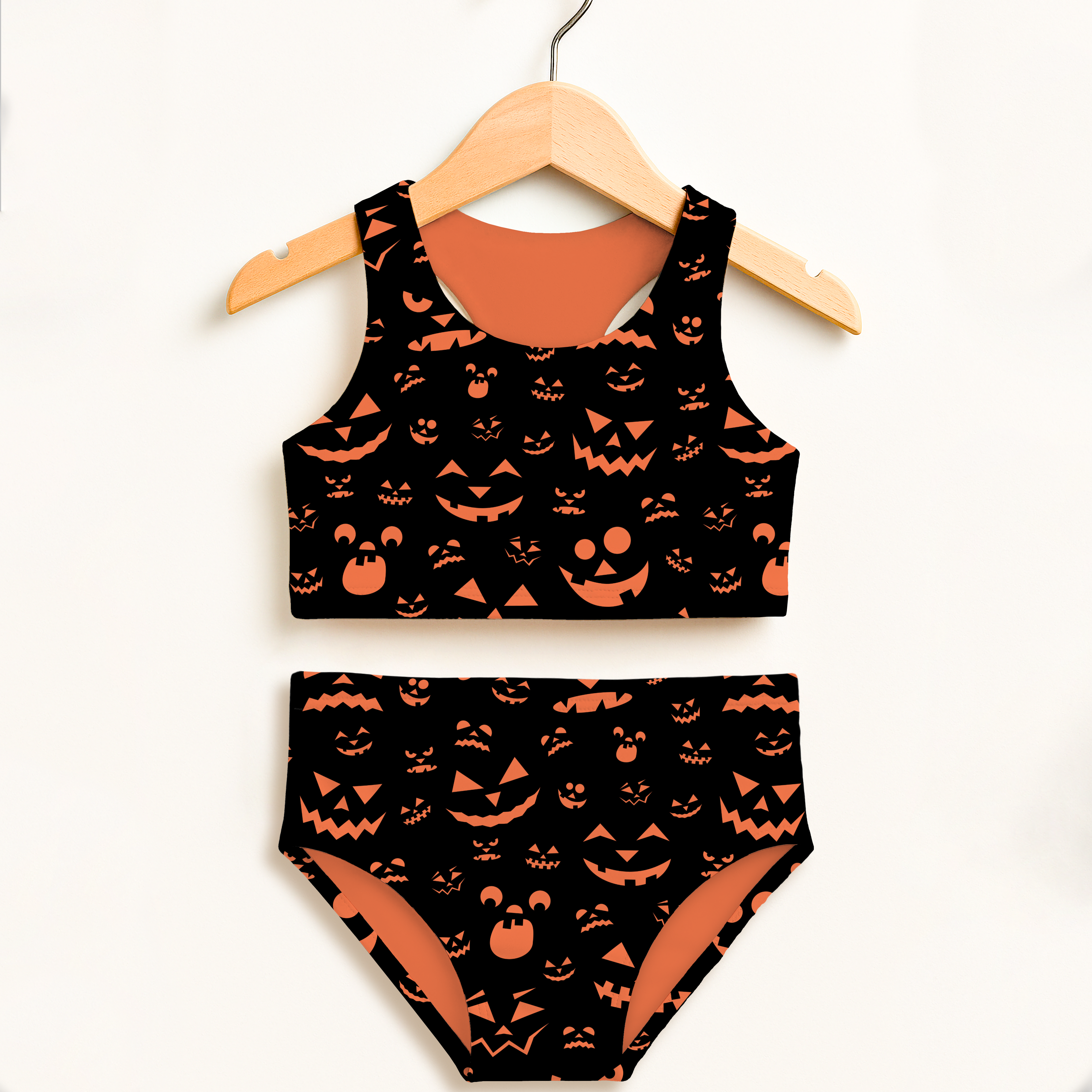 Girls orange jack-o-lantern halloween two piece swimsuit with playful pattern double layered upf 50 high waisted