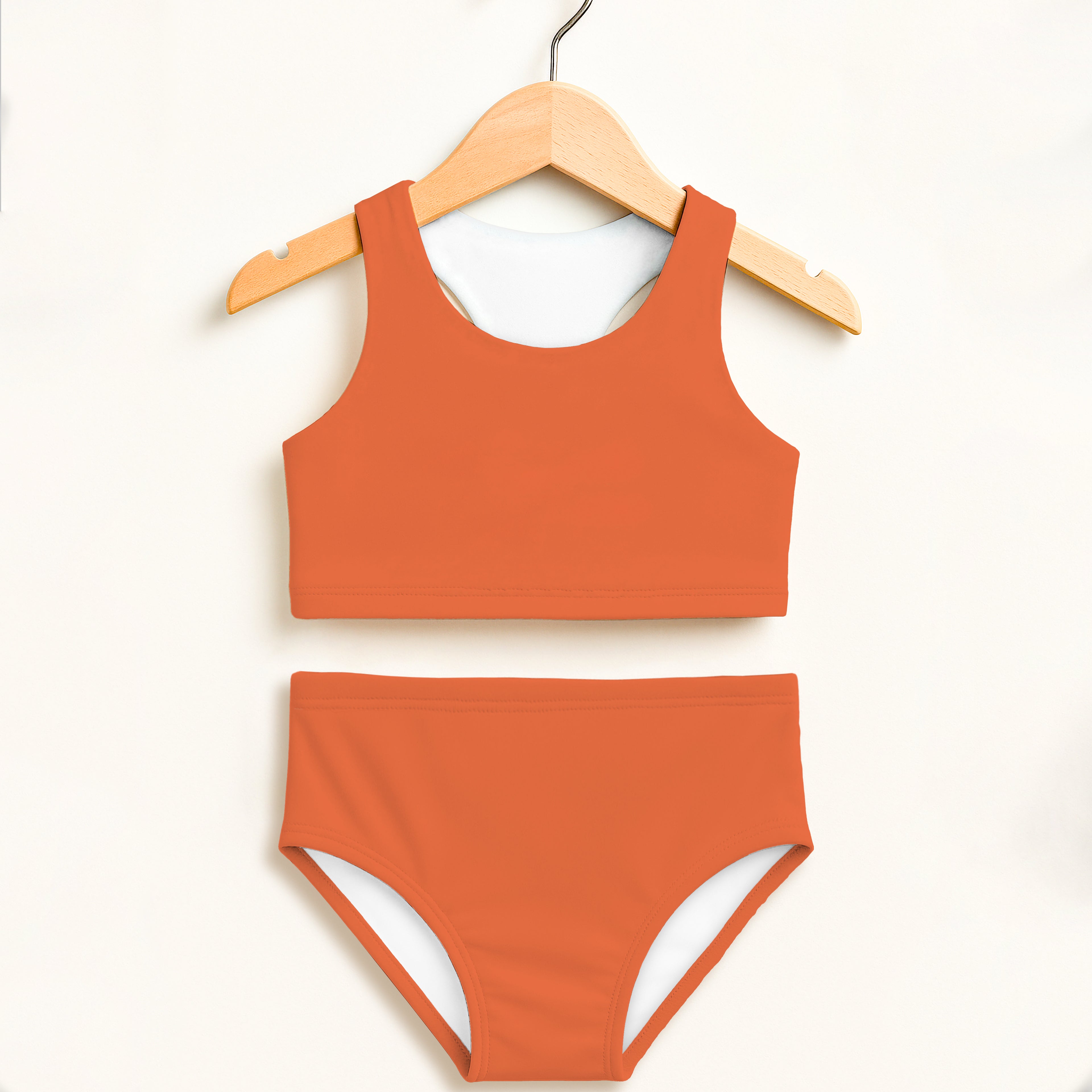 Girls orange two piece swimsuit with white lining double layered UPF 50 plus high waisted comfort design