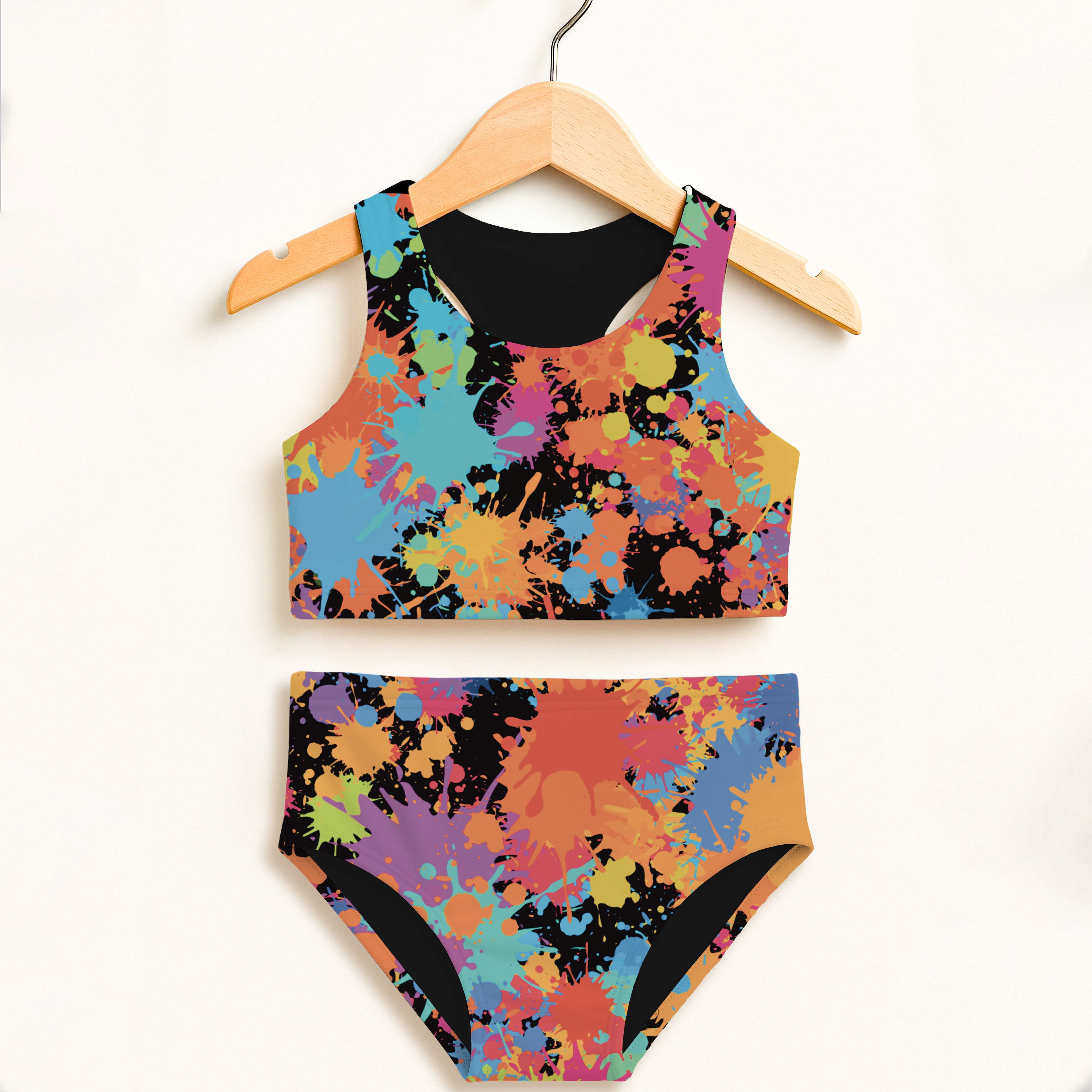 Girls paint splatter two piece swimsuit with vibrant multicolored print black lining high waisted double layered upf 50 plus