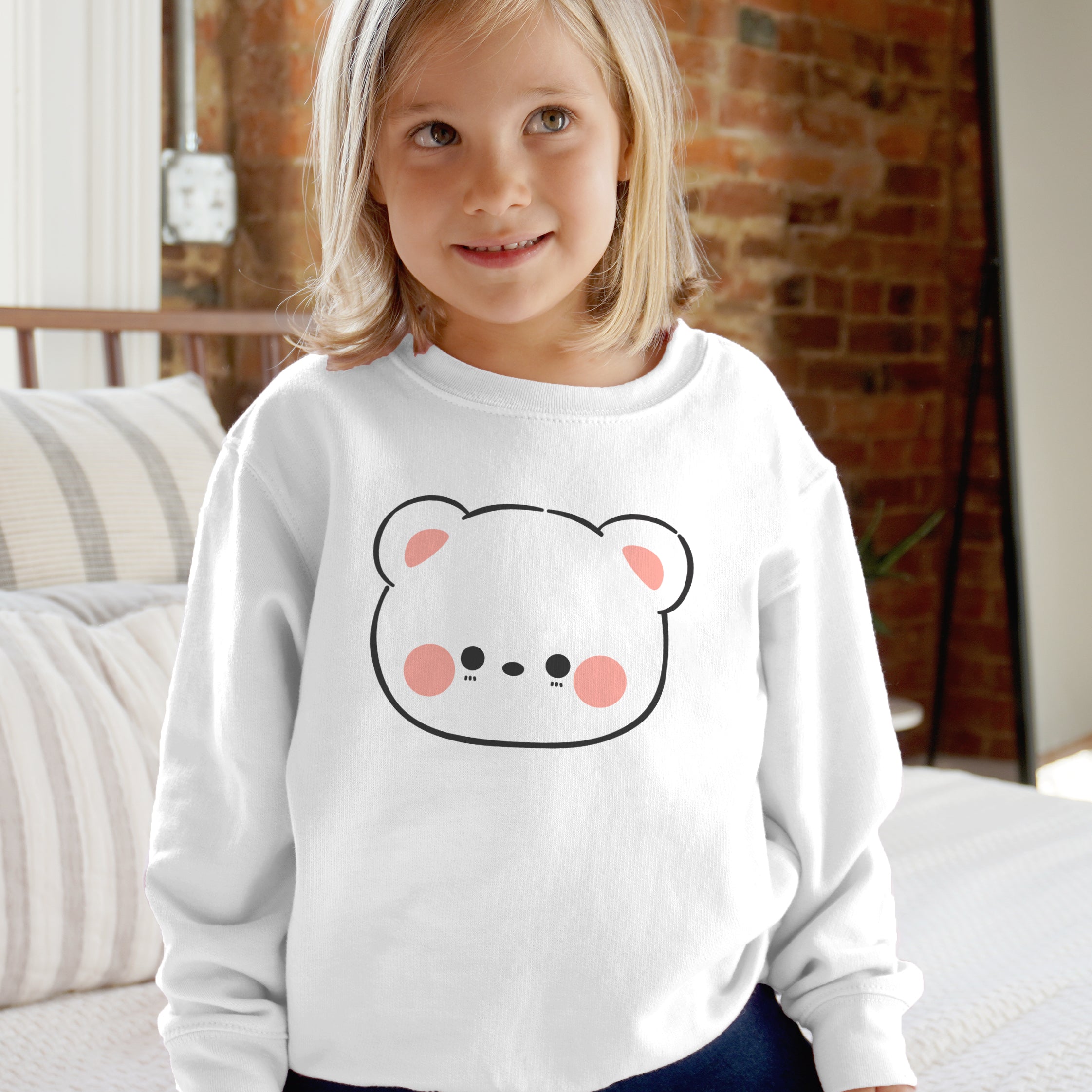 White kids fleece sweatshirt with long sleeves and a kawaii cartoon bear face in black outline and pink accents