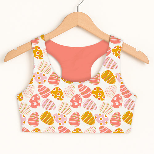 Girls coral and pink Easter egg sports bra with quick drying fabric double layered comfort and pastel pattern