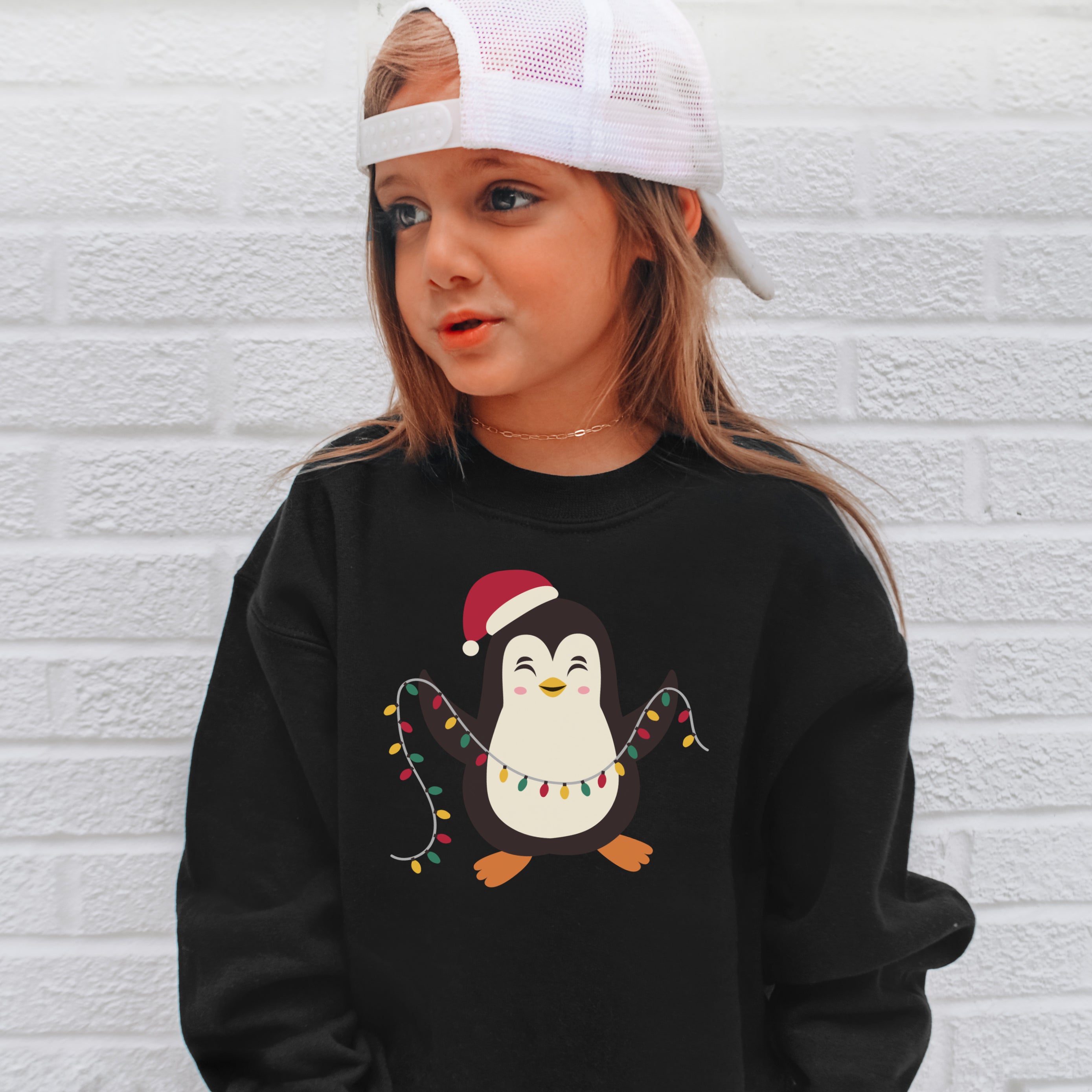 Black long-sleeved kids Christmas penguin sweatshirt with cartoon penguin wearing santa hat holding colorful lights