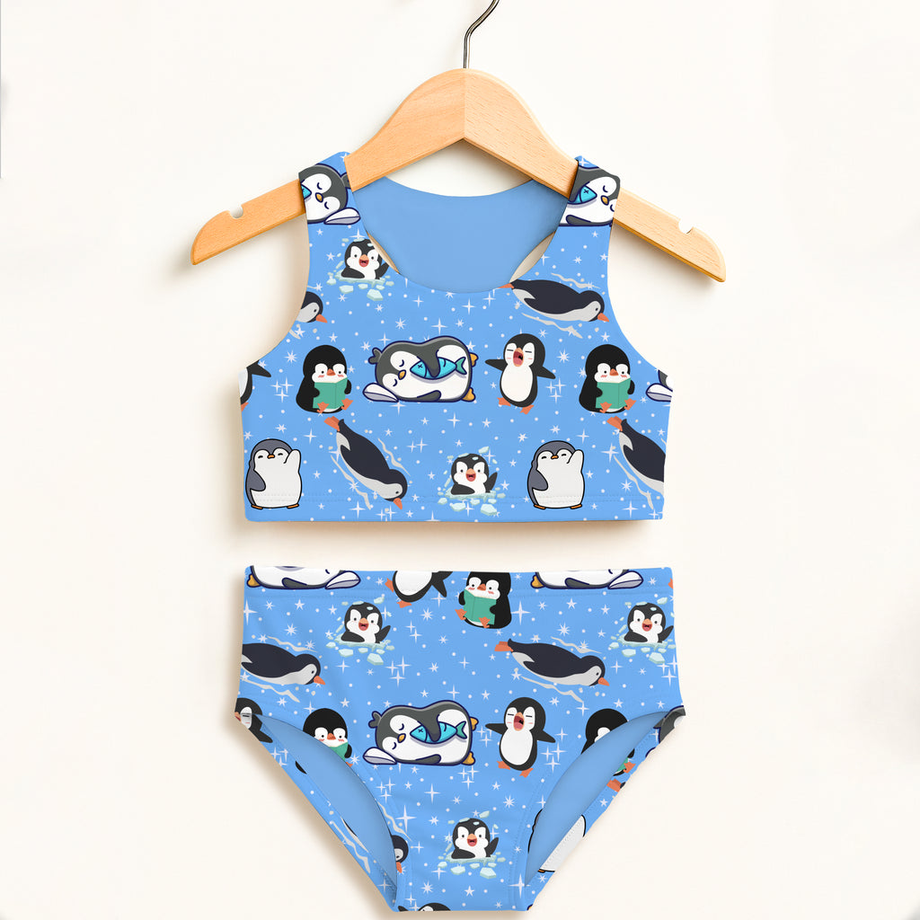 Girls penguin two piece swimsuit with cartoon black and white penguins on light blue double layered upf 50 high waisted fabric