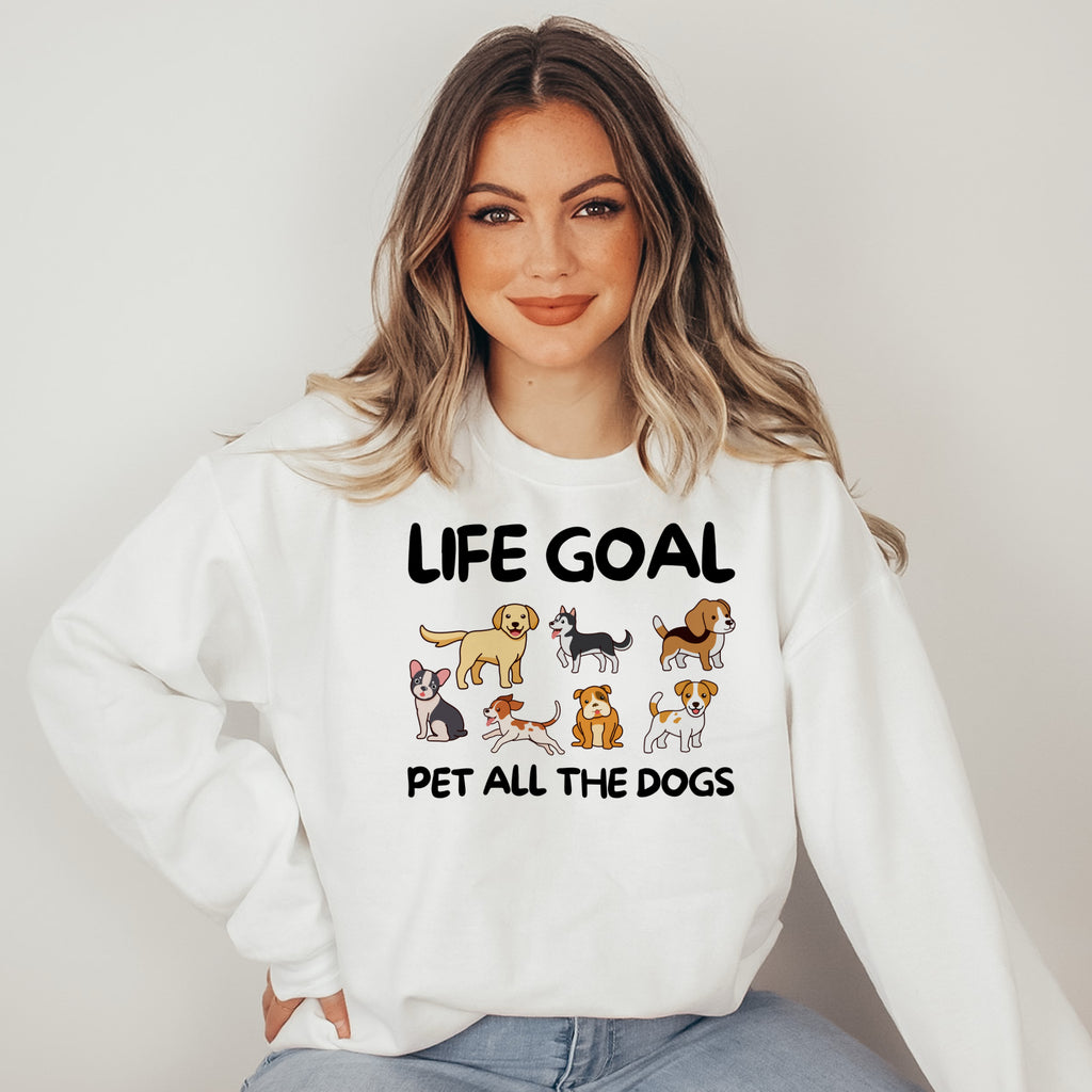 Woman wearing a white sweatshirt with 'Life Goal Pet All The Dogs' text and dog illustrations.