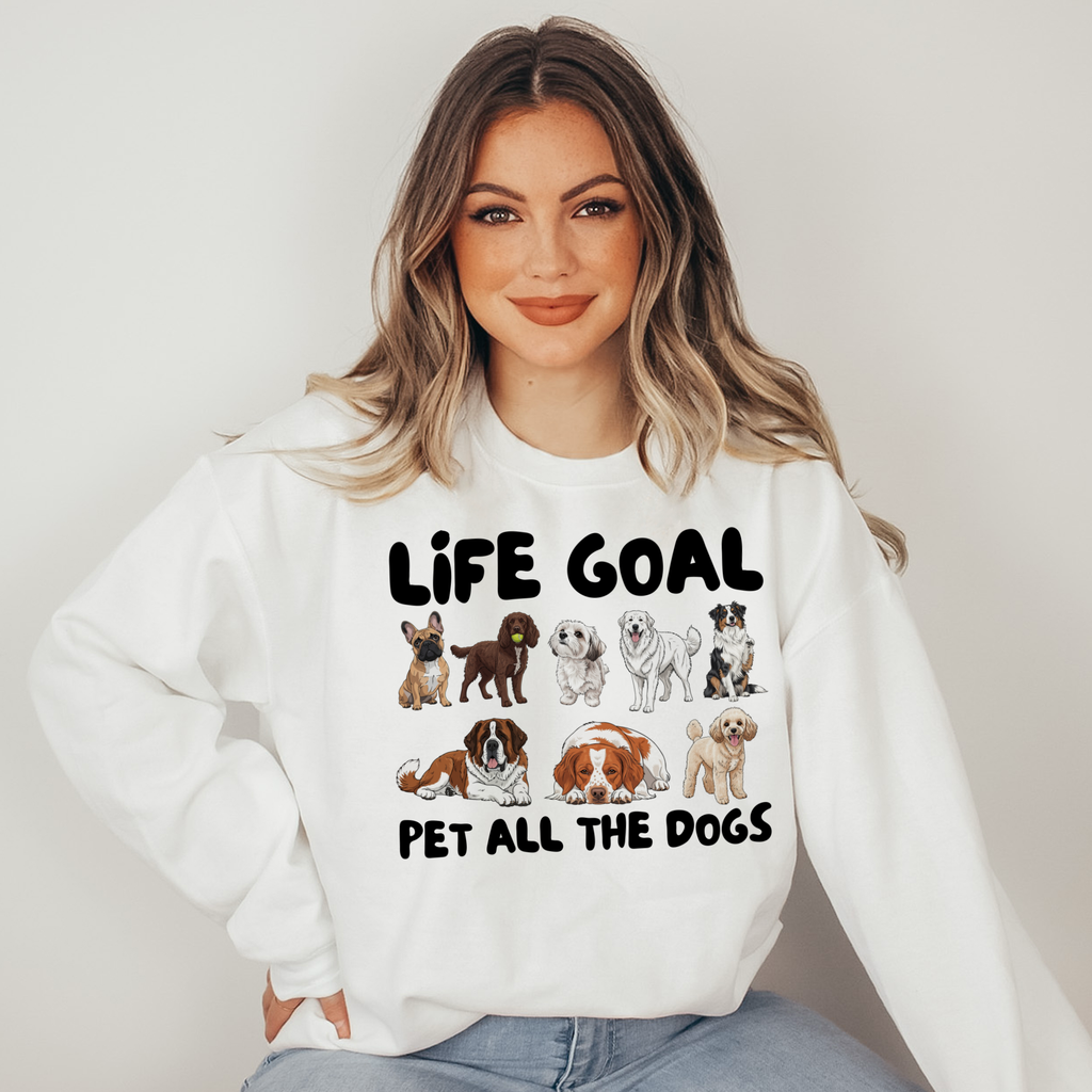Woman wearing a white sweatshirt with dog illustrations and text on a plain background