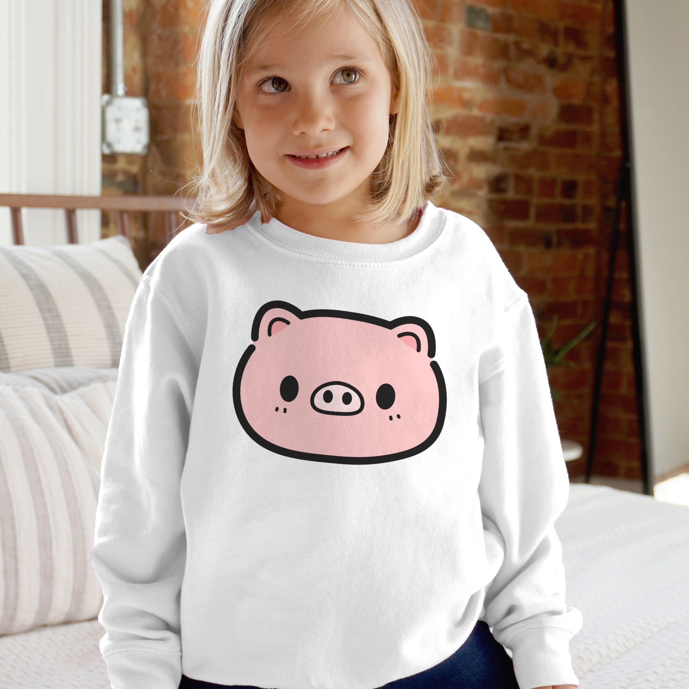 Kids pink pig sweatshirt featuring a white long-sleeved cotton sweatshirt with a pink cartoon pig face print