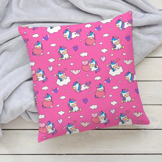 pink pillow with unicorns and hearts on it