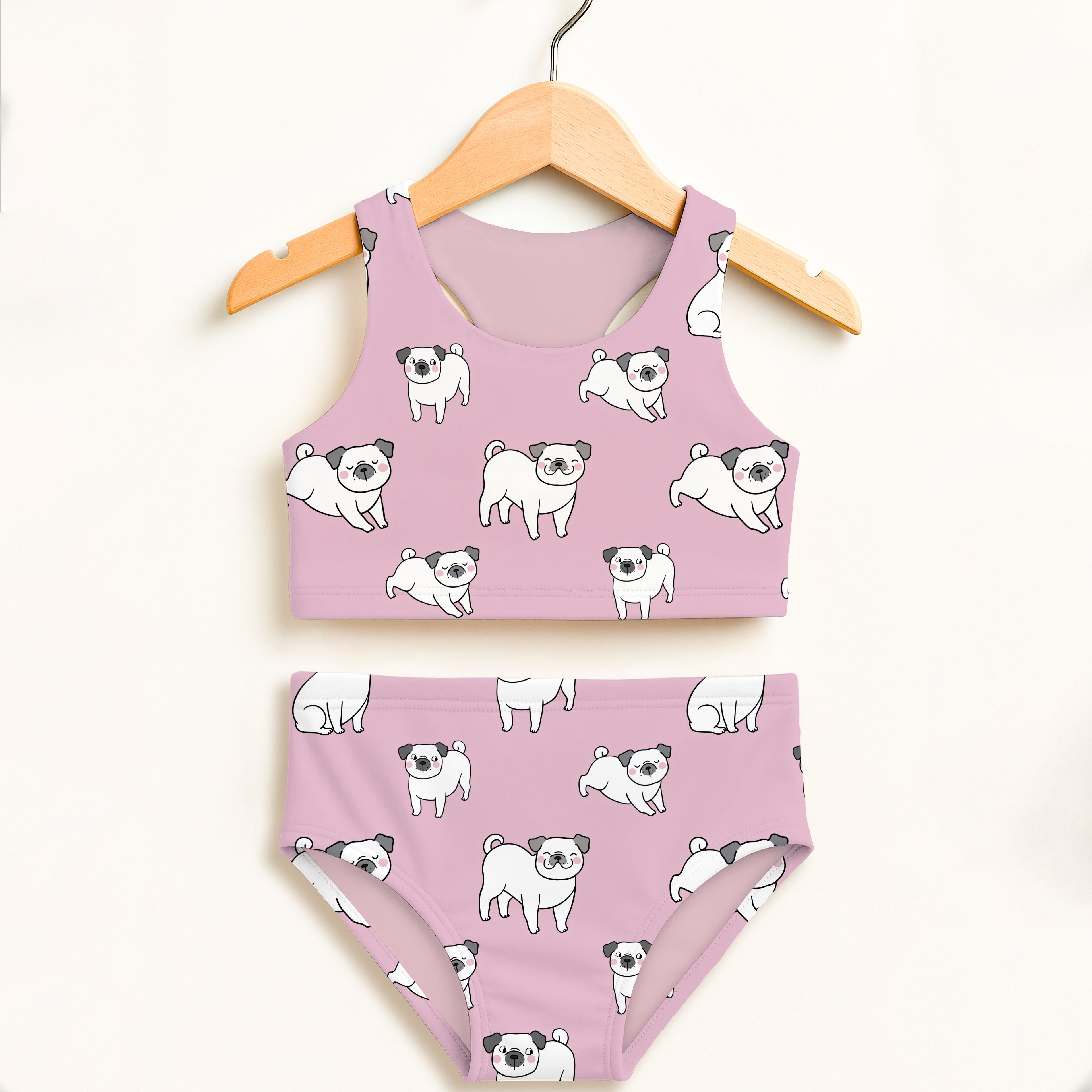 Girls pink pug two piece swimsuit with playful white cartoon pugs black ears and noses double layered upf 50 high waisted