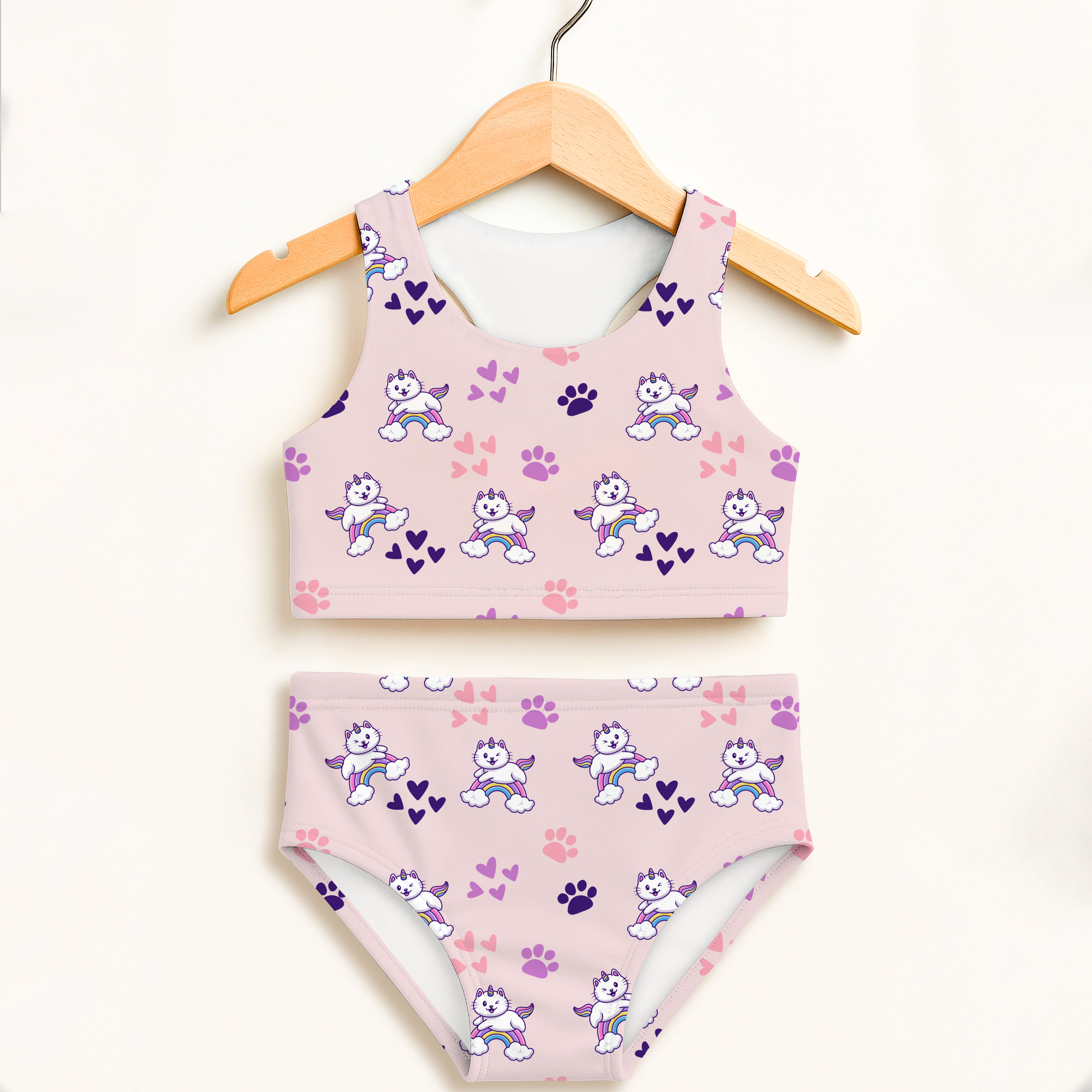Girls pink caticorn two piece swimsuit with white winged cartoon dogs rainbows and paw prints upf 50 plus fabric