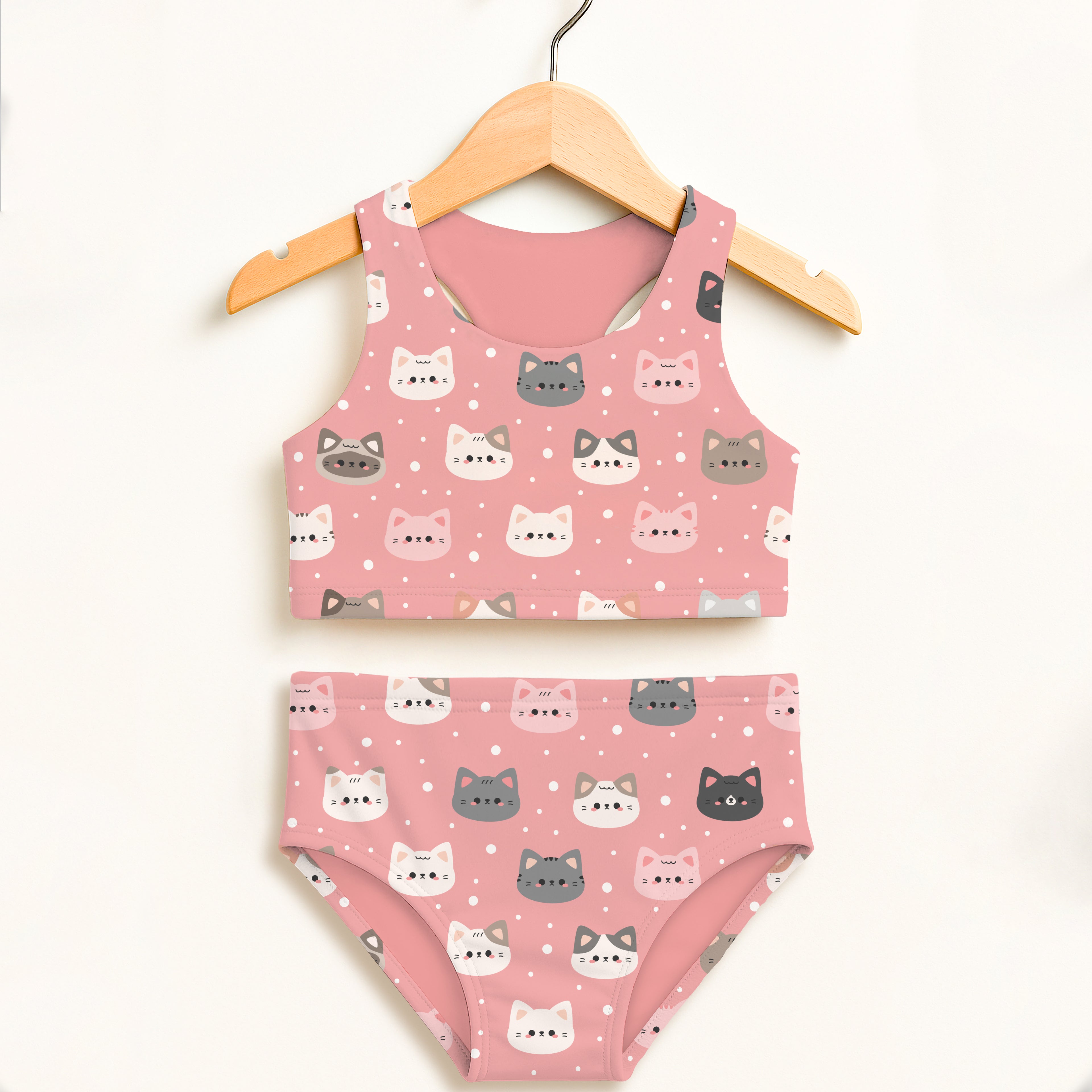 Girls pink two piece swimsuit with pink cat-themed soft fabric and white and gray cartoon faces upf 50 plus high waisted comfort