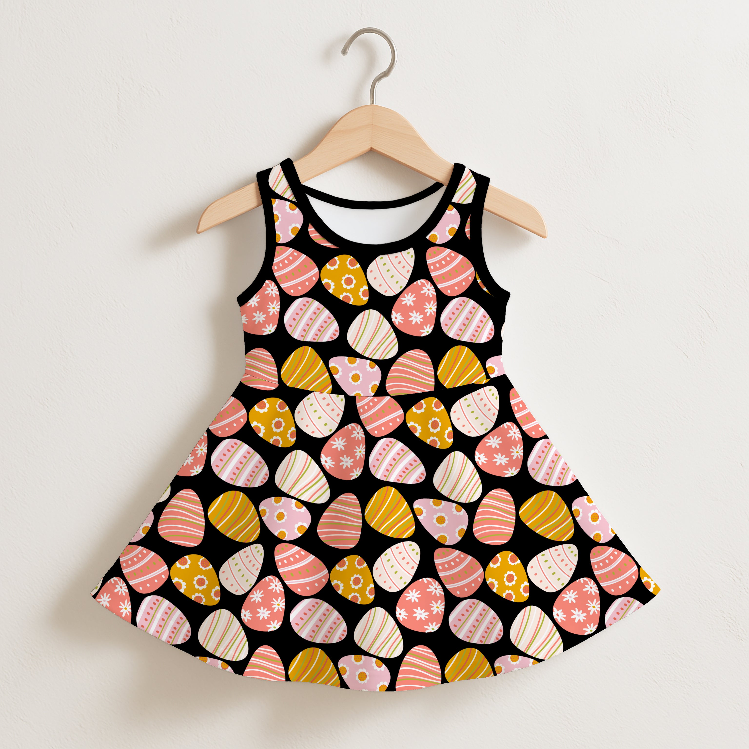 Girls pink easter eggs sleeveless dress featuring a black base with pastel pink yellow and white egg patterns