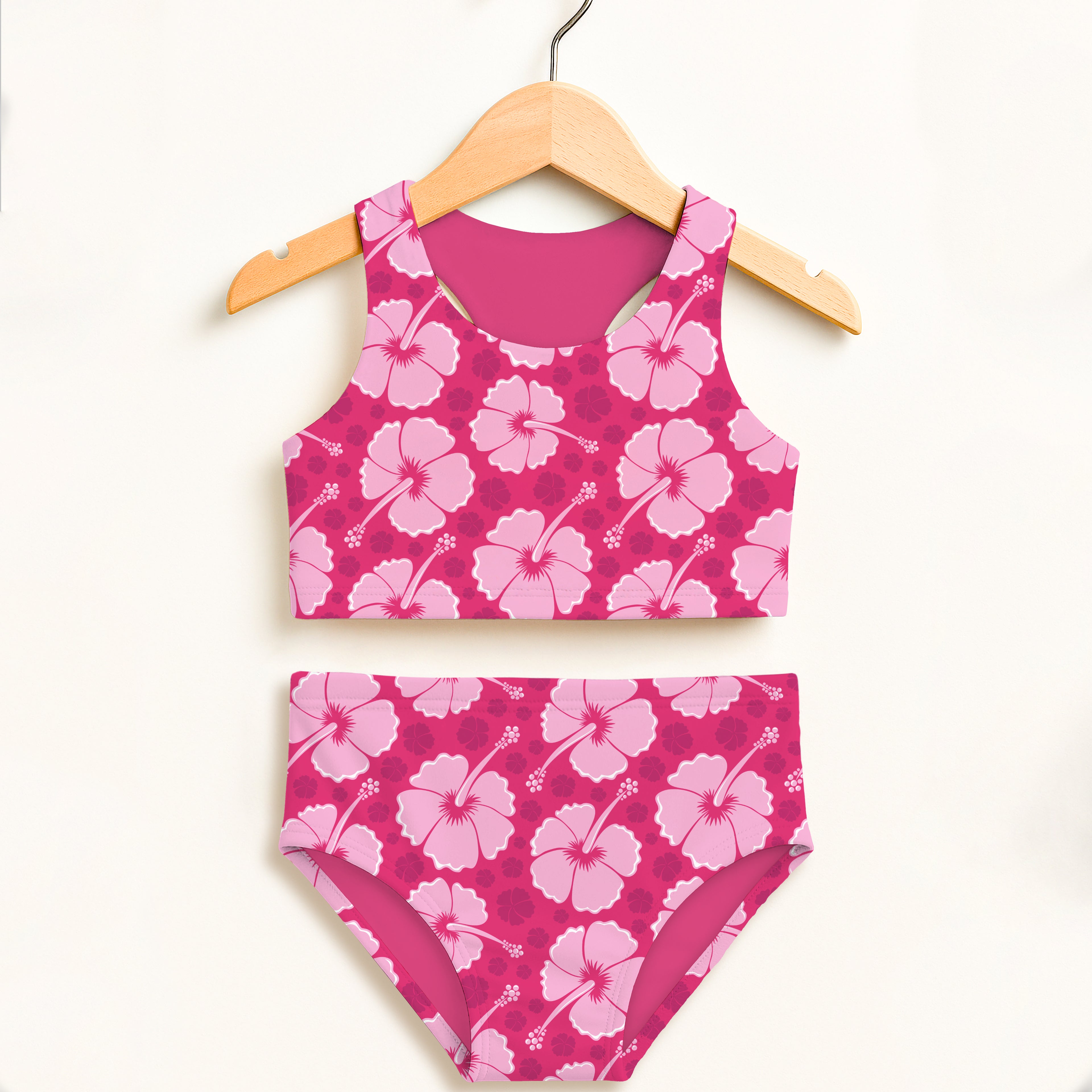 Girls tropical pink hibiscus two piece swimsuit with solid magenta interior lining and UPF 50 plus high waisted comfort