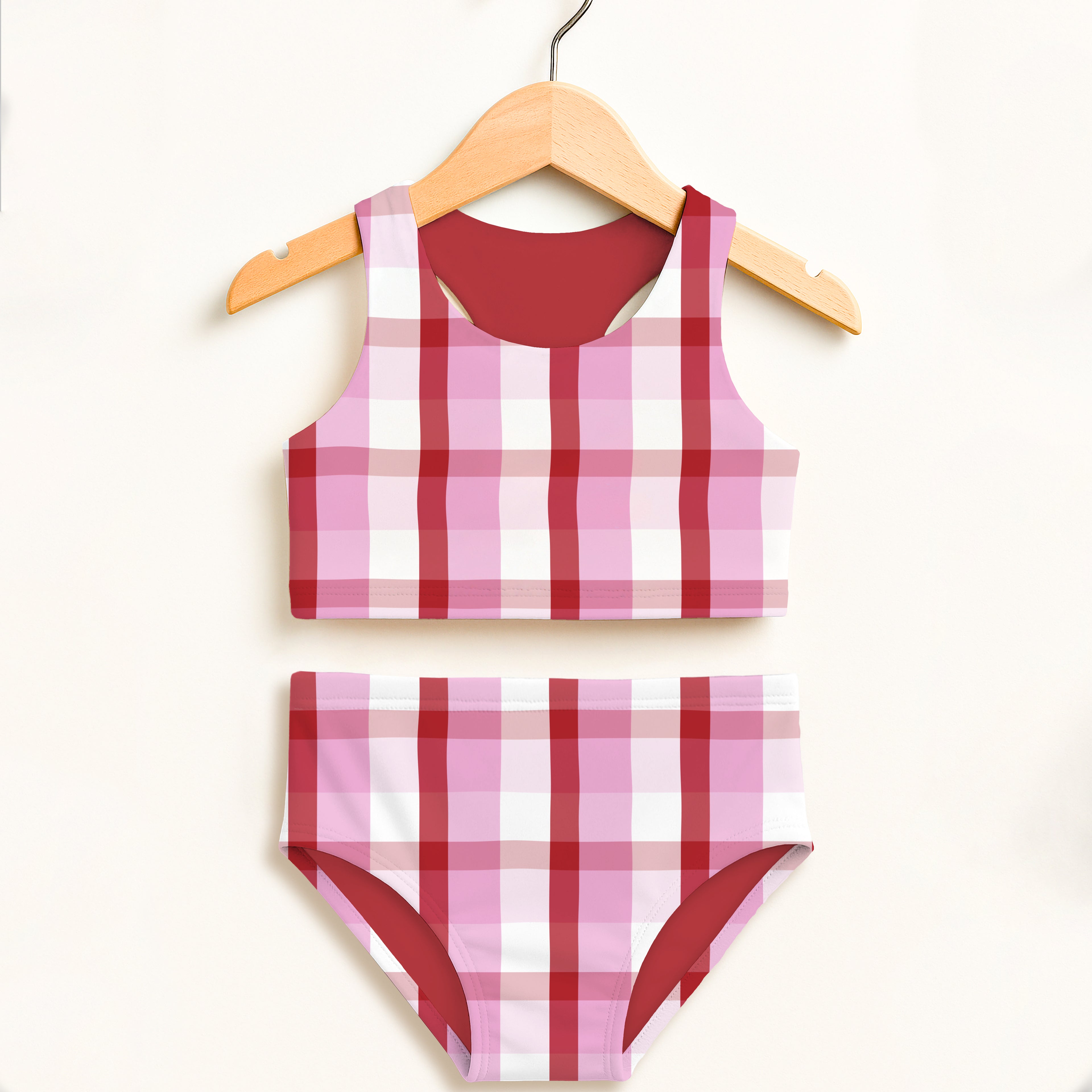 Girls pink gingham two piece swimsuit with double layered fabric and red trim offering UPF 50 plus sun protection