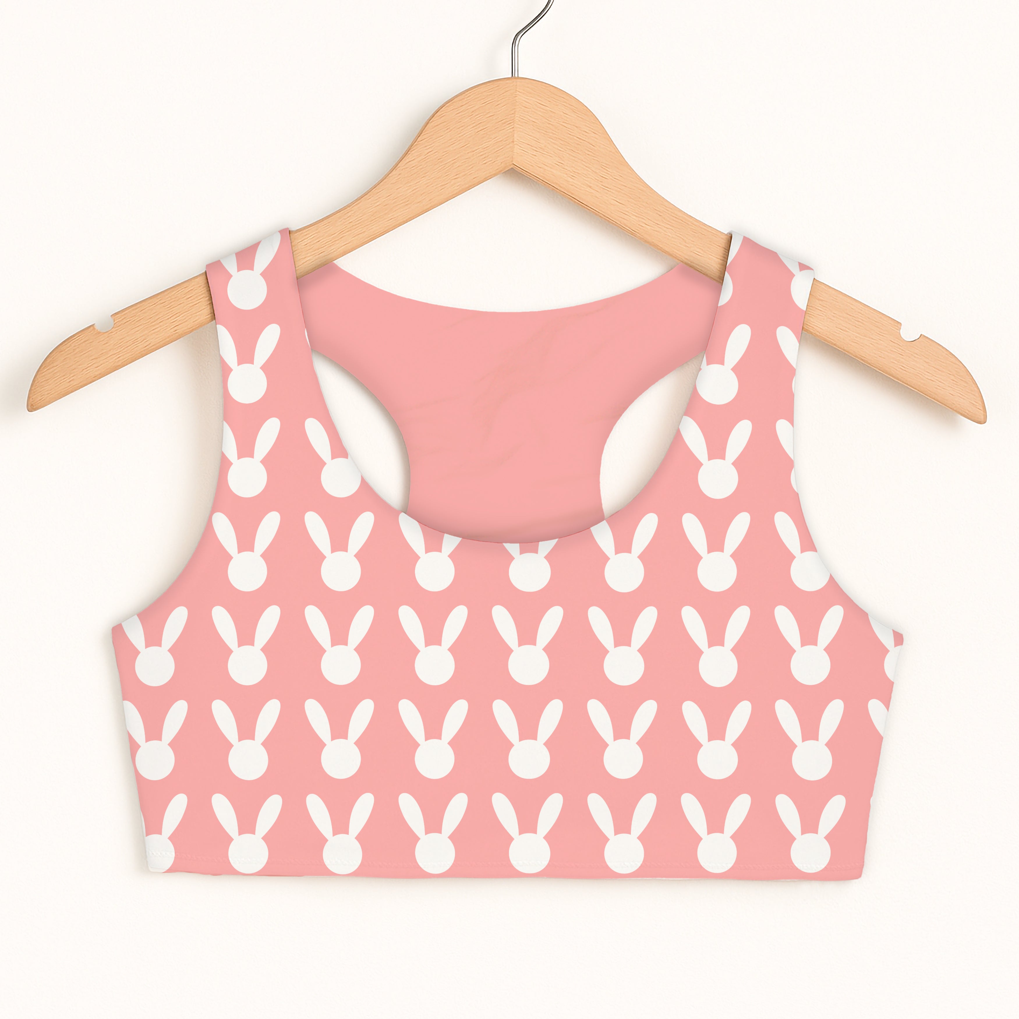 Girls pink bunny sports bra with white bunny face pattern hanging on wooden hanger quick drying double layered comfort