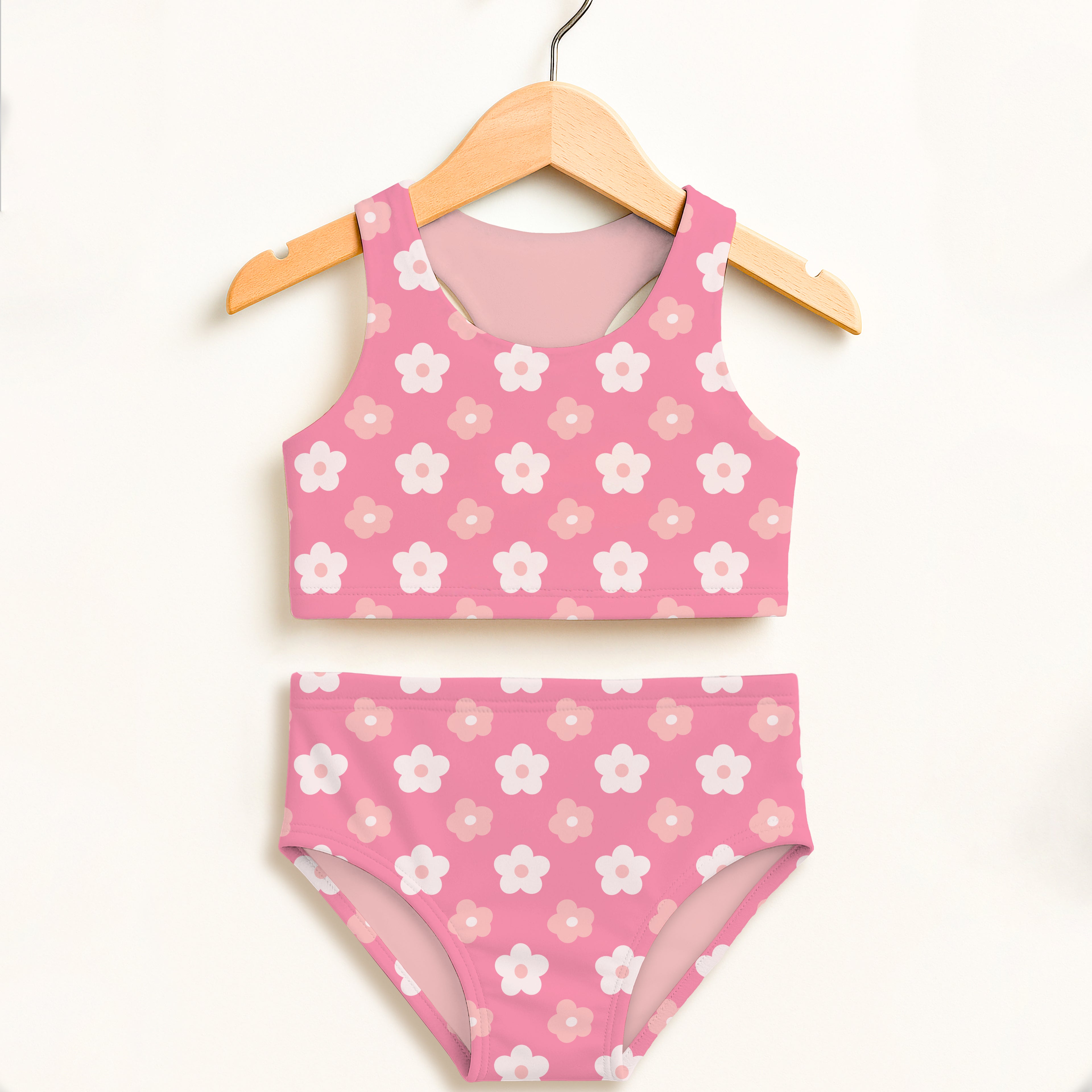 Girls pink daisy flowers two-piece swimsuit with white and light pink blossoms on soft stretchy fabric and upf 50+ protection
