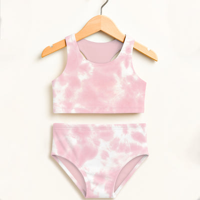 Girls pink and white tie dye two piece swimsuit hanging on wooden hanger with double layered upf 50 plus fabric