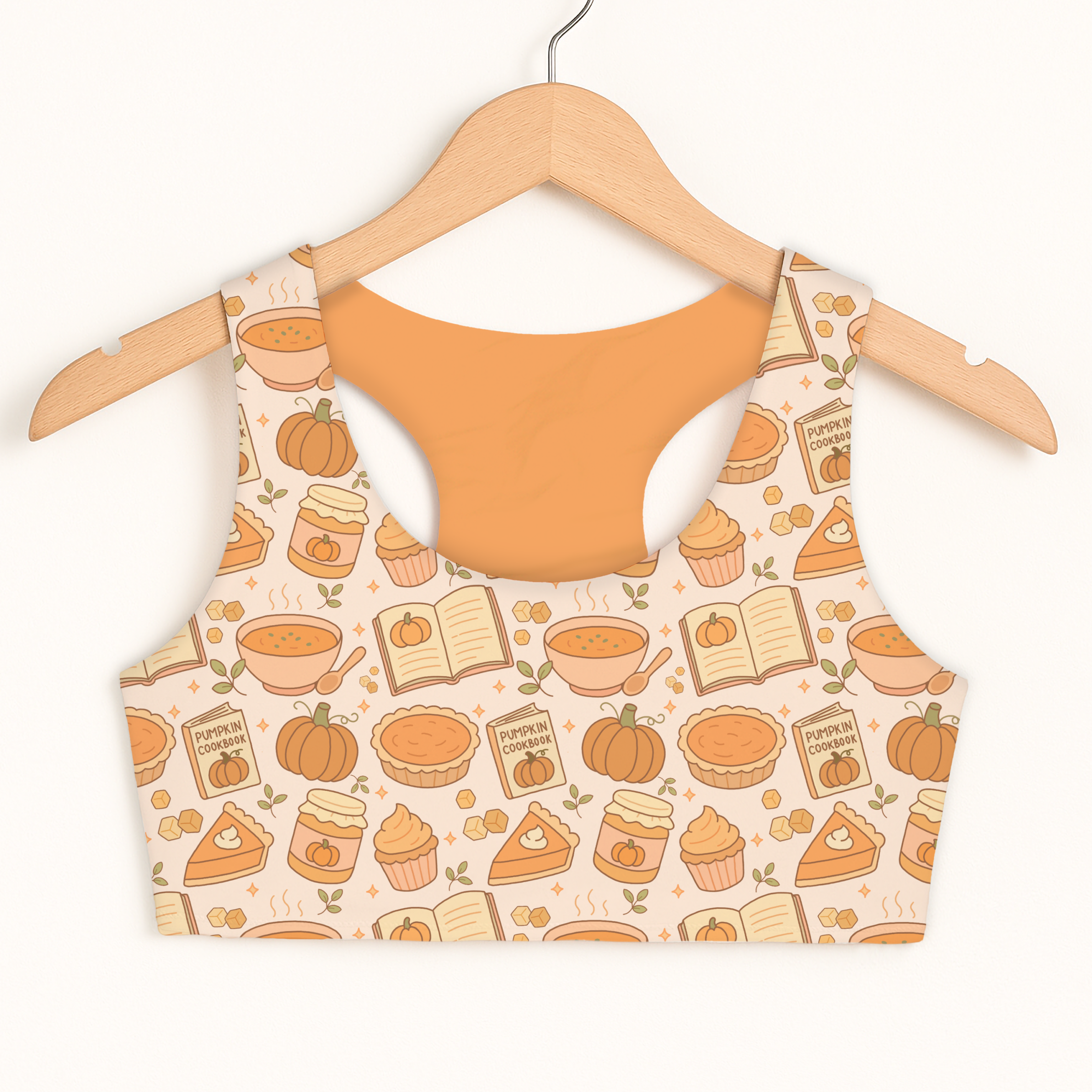 Beige girls pumpkin pie themed sports bra with orange pumpkin pattern featuring pies books and pumpkins, quick drying and double layered