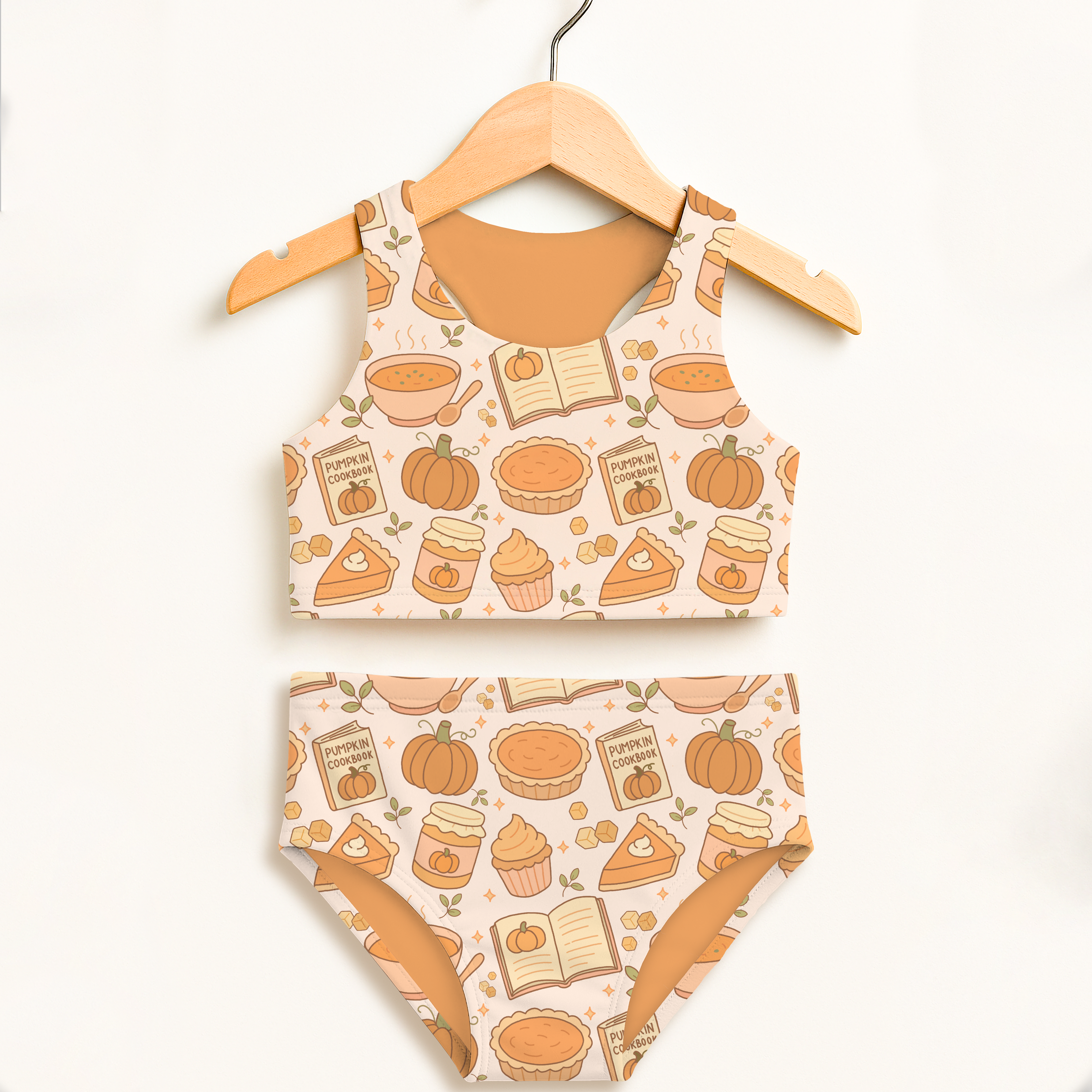 Girls pumpkin pie themed two piece swimsuit in cream with pumpkin cookbook pattern and upf 50 plus high waisted comfort