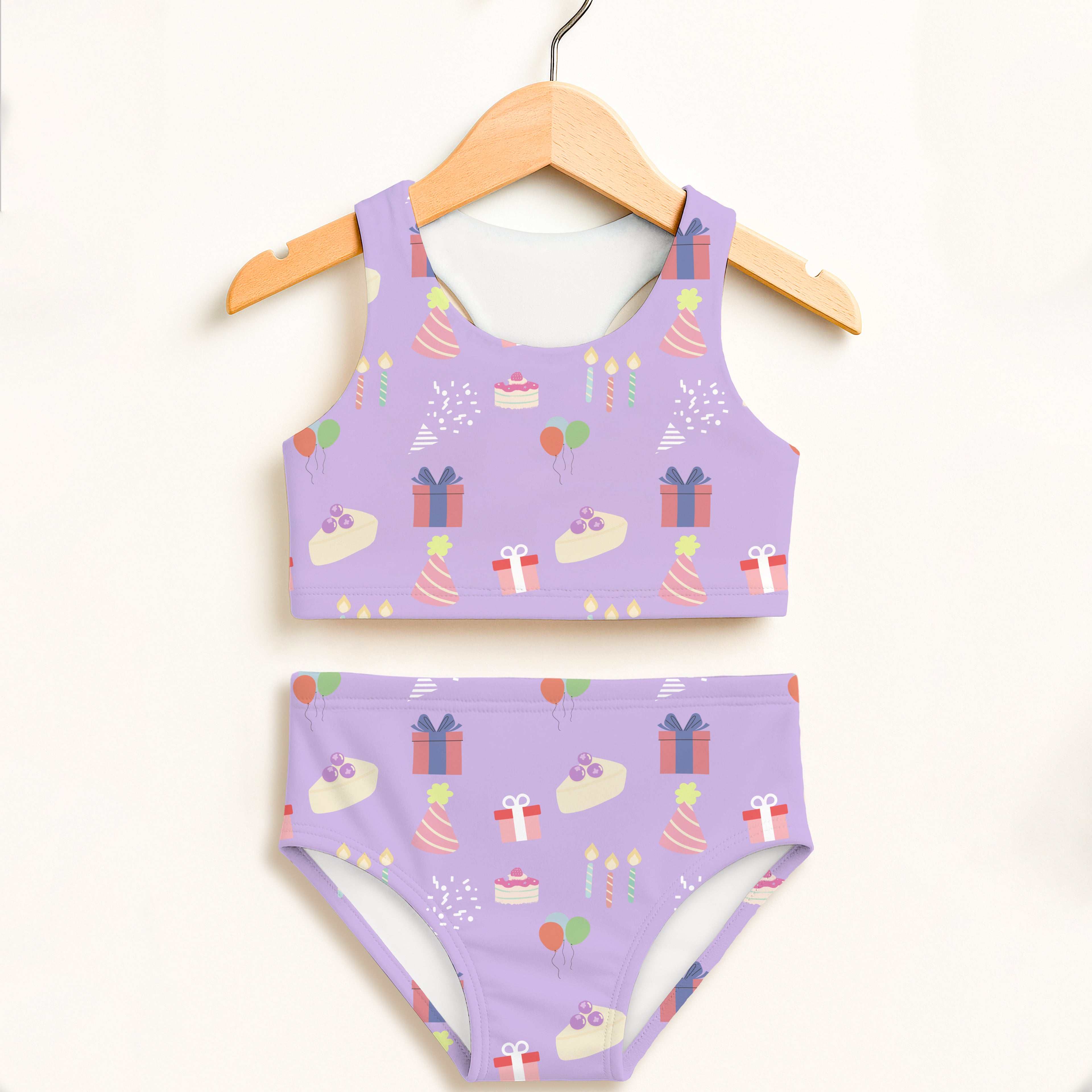 Girls purple birthday party two piece swimsuit with festive cake, presents, hats, and balloons design, double layered upf 50+