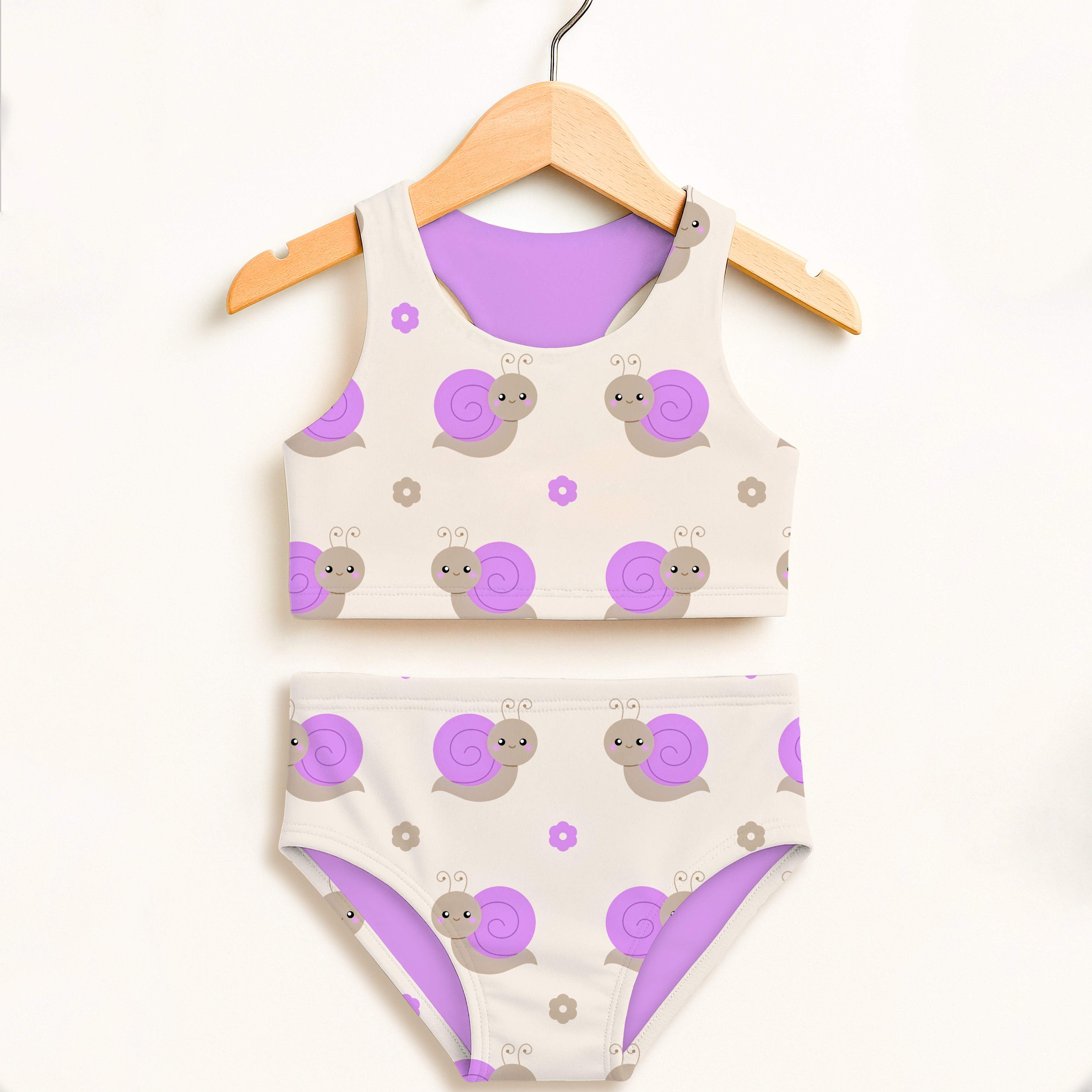 Girls purple snail two piece swimsuit with playful pattern on cream base and lavender lining double layered upf 50+ high waisted