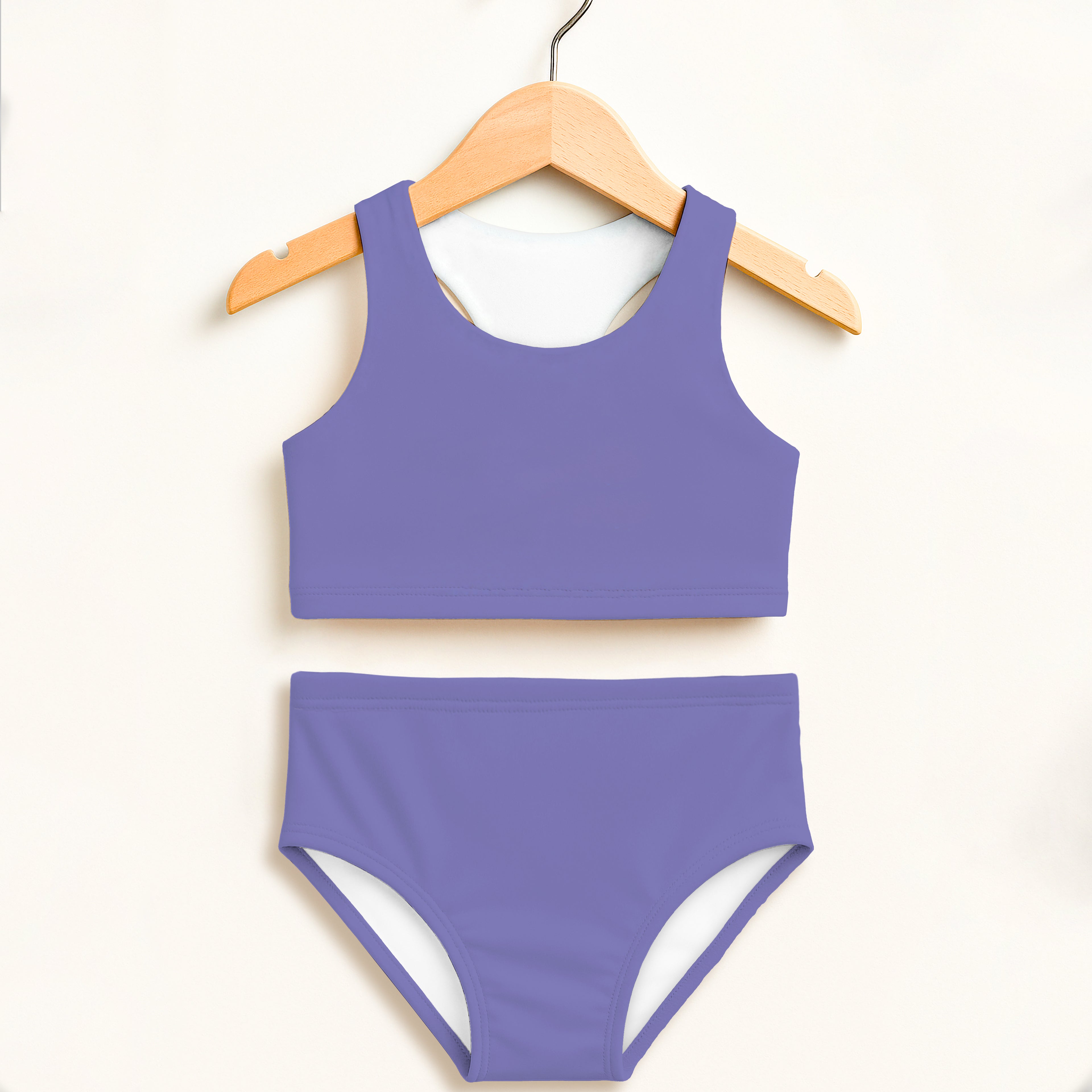 Girls purple two-piece swimsuit with white lining featuring a halter top and high-waisted double layered UPF 50+ comfort