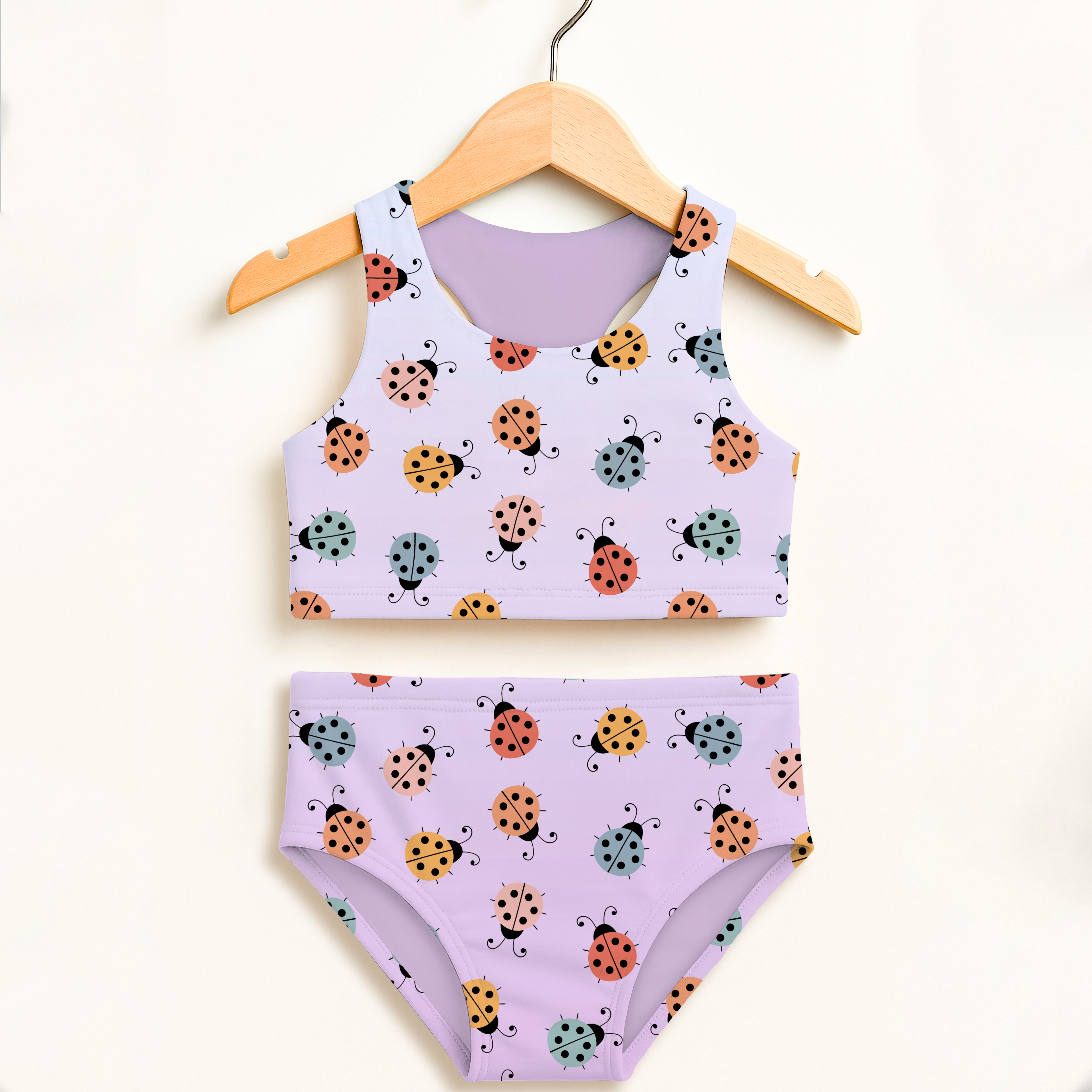 Pastel lavender girls colorful ladybug two piece swimsuit with playful pattern and upf 50 plus high waisted comfort