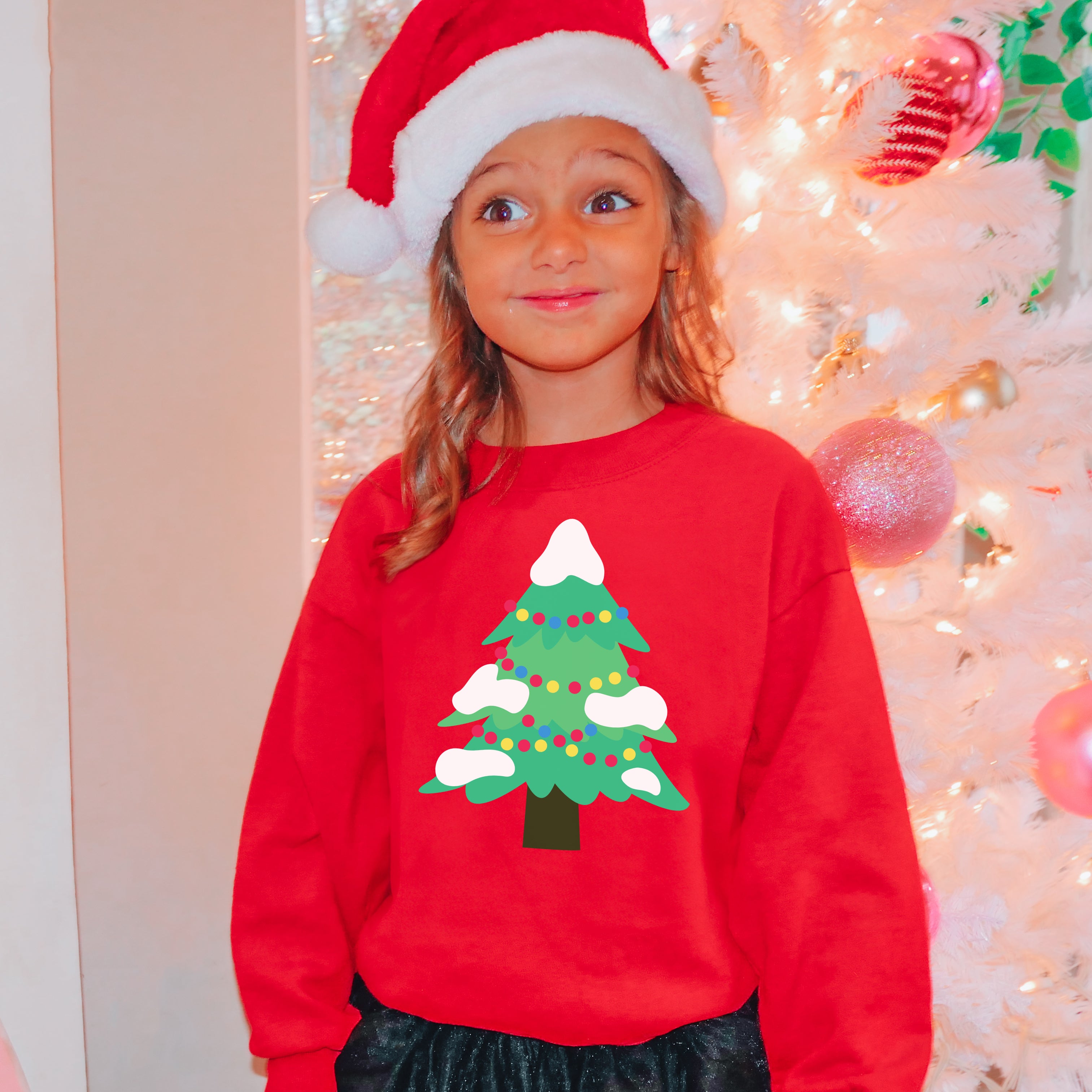 Kids christmas tree sweatshirt in red with green pine tree design, colorful lights, and white snow accents