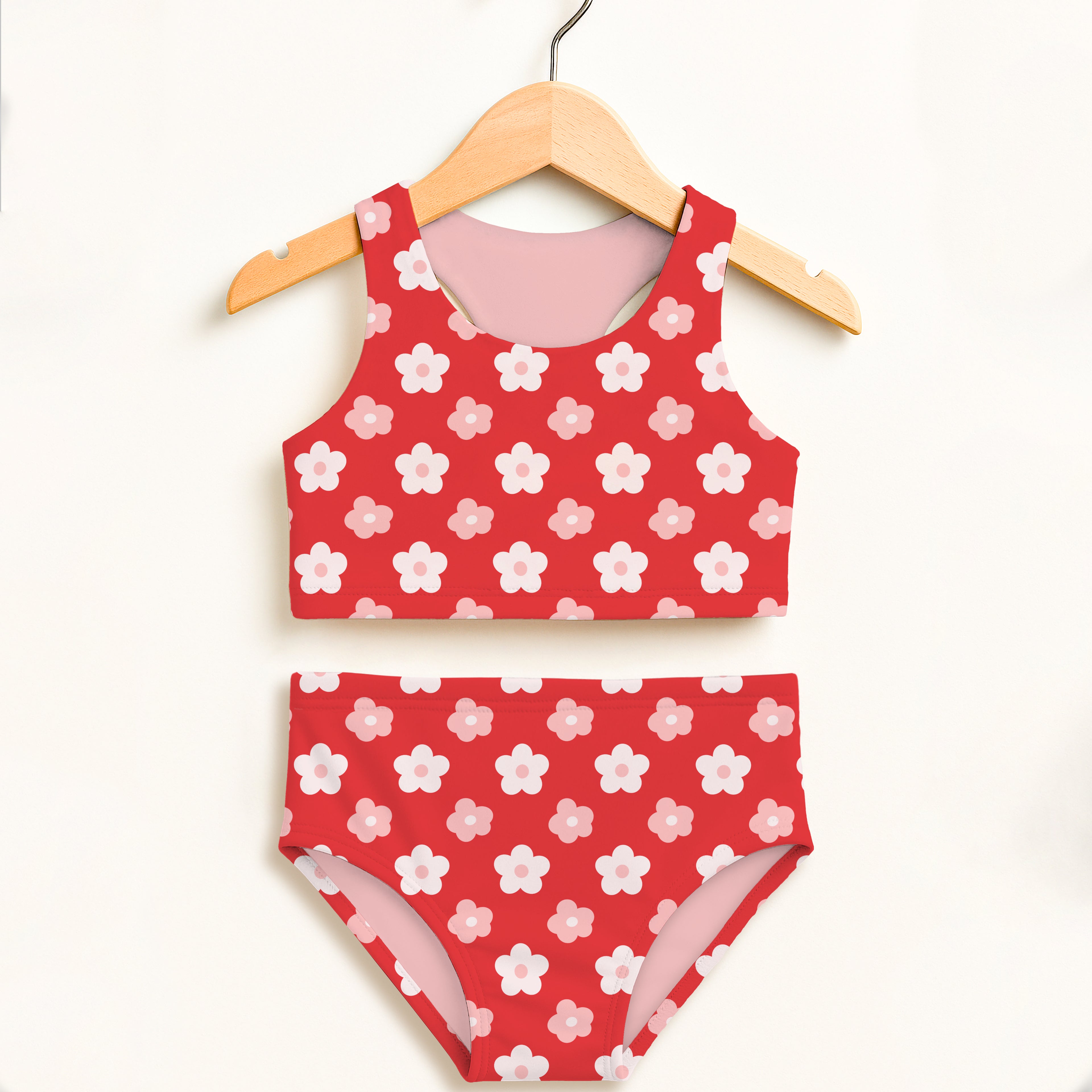 Girls red daisy flowers two piece swimsuit with white and pink blossoms on vibrant red high waisted fabric