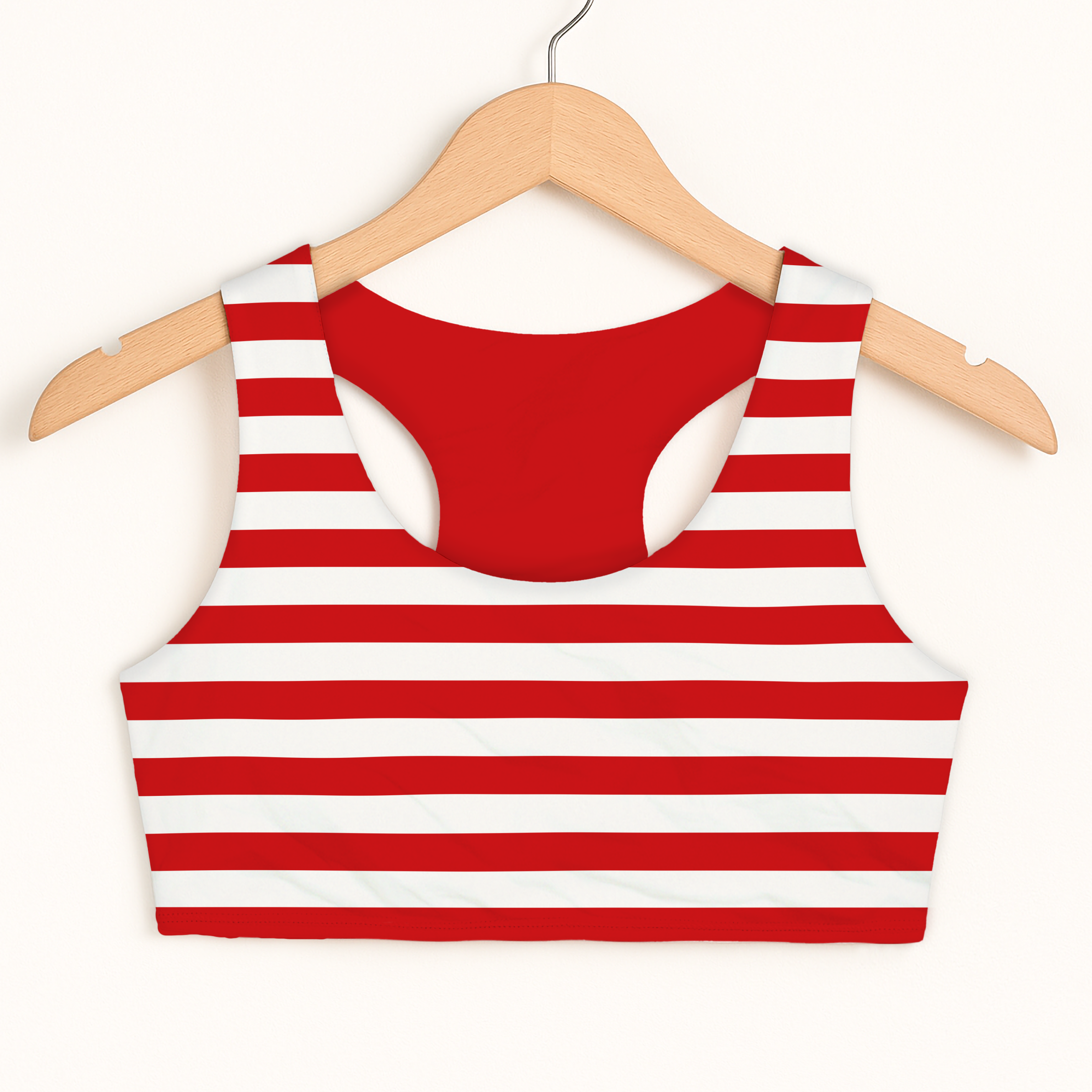 Back view of girls red striped christmas sports bra with quick drying fabric and solid red back panel