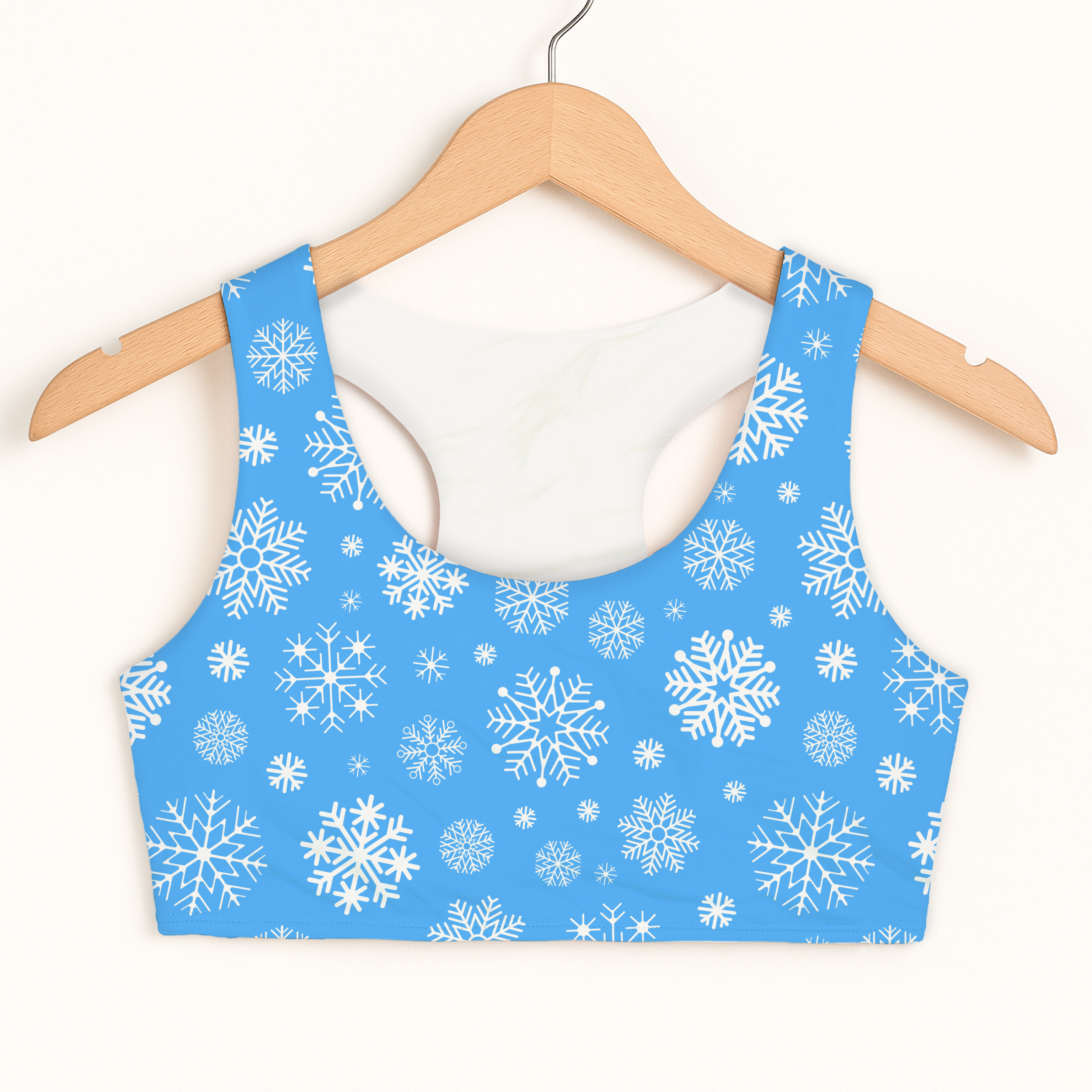 Girls blue snowflakes Christmas sports bra with quick drying fabric and double layered comfort hanging on wooden hanger