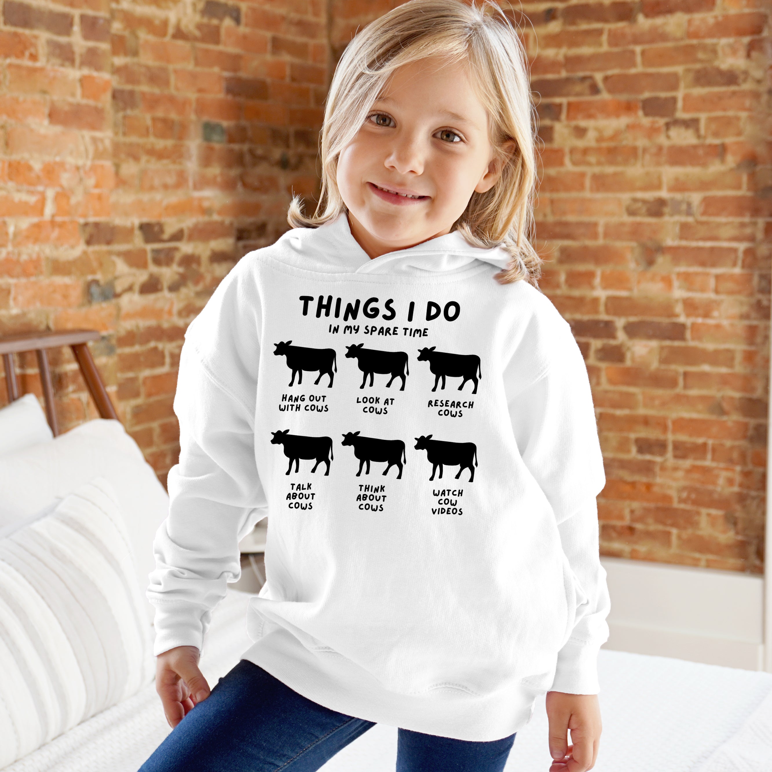 White kids hoodie with black cow silhouettes and text things i do in my spare time on front print