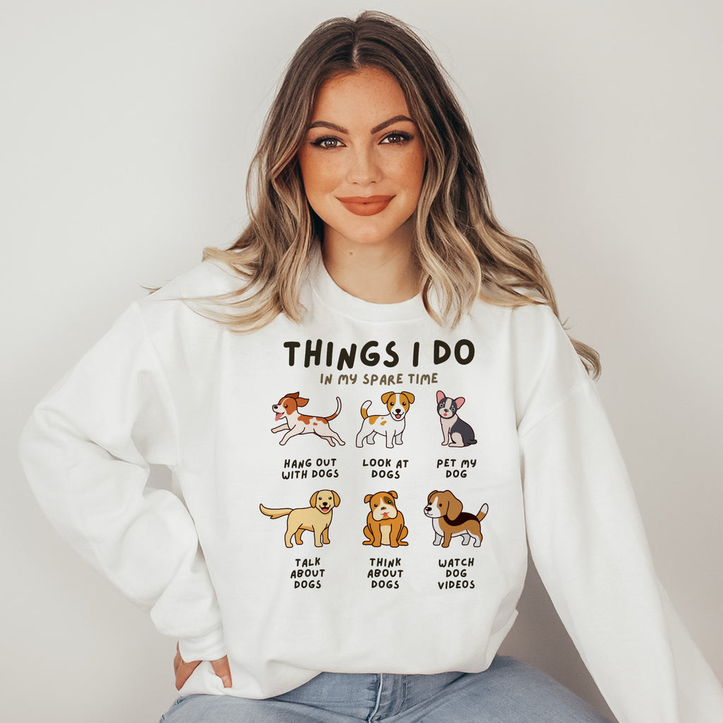 Woman wearing a white sweatshirt with dog-themed graphics and text.