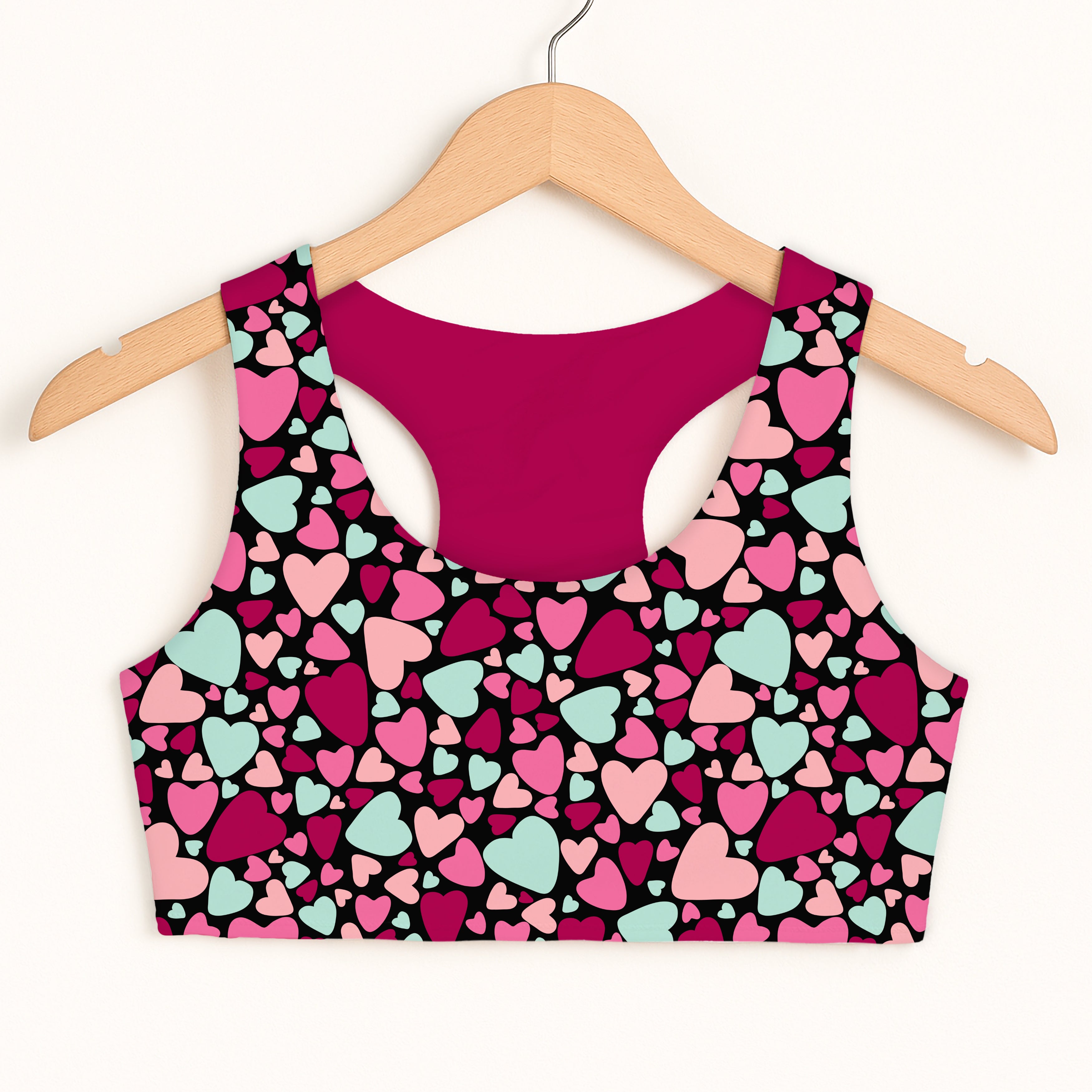 A vibrant black girls colorful heart sports bra with quick drying fabric and double layered comfort features pink magenta and mint hearts
