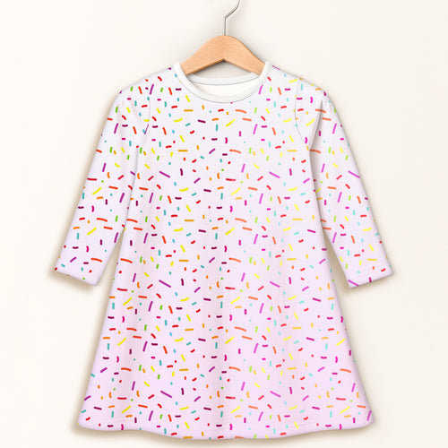 Girls colorful sprinkles long sleeve dress features a pink fabric with a playful multicolored sprinkle pattern